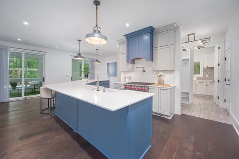 a kitchen with stainless steel appliances white cabinets and a sink