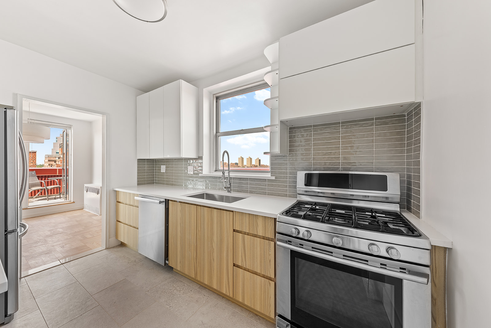 110-50 71st Road, Unit PHD Queens, NY 11375 - Photo 3 of 14 a kitchen with a stove a sink and a microwave