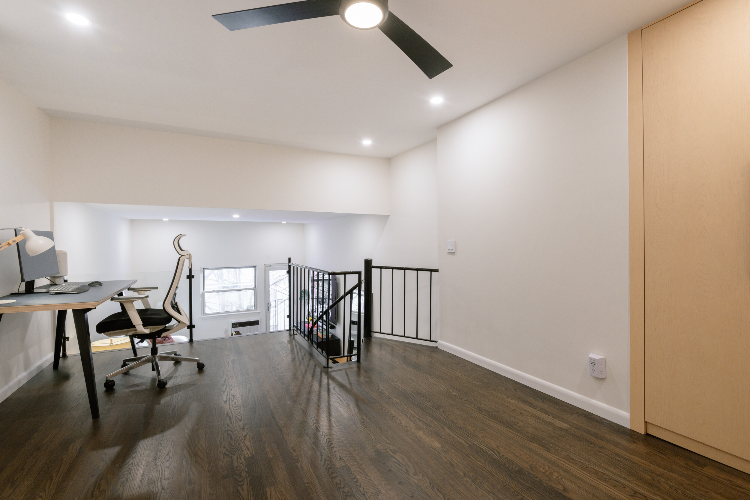 211 Thompson Street, Unit 4J Manhattan, NY 10012 - Photo 6 of 8 a view of a livingroom with furniture and wooden floor
