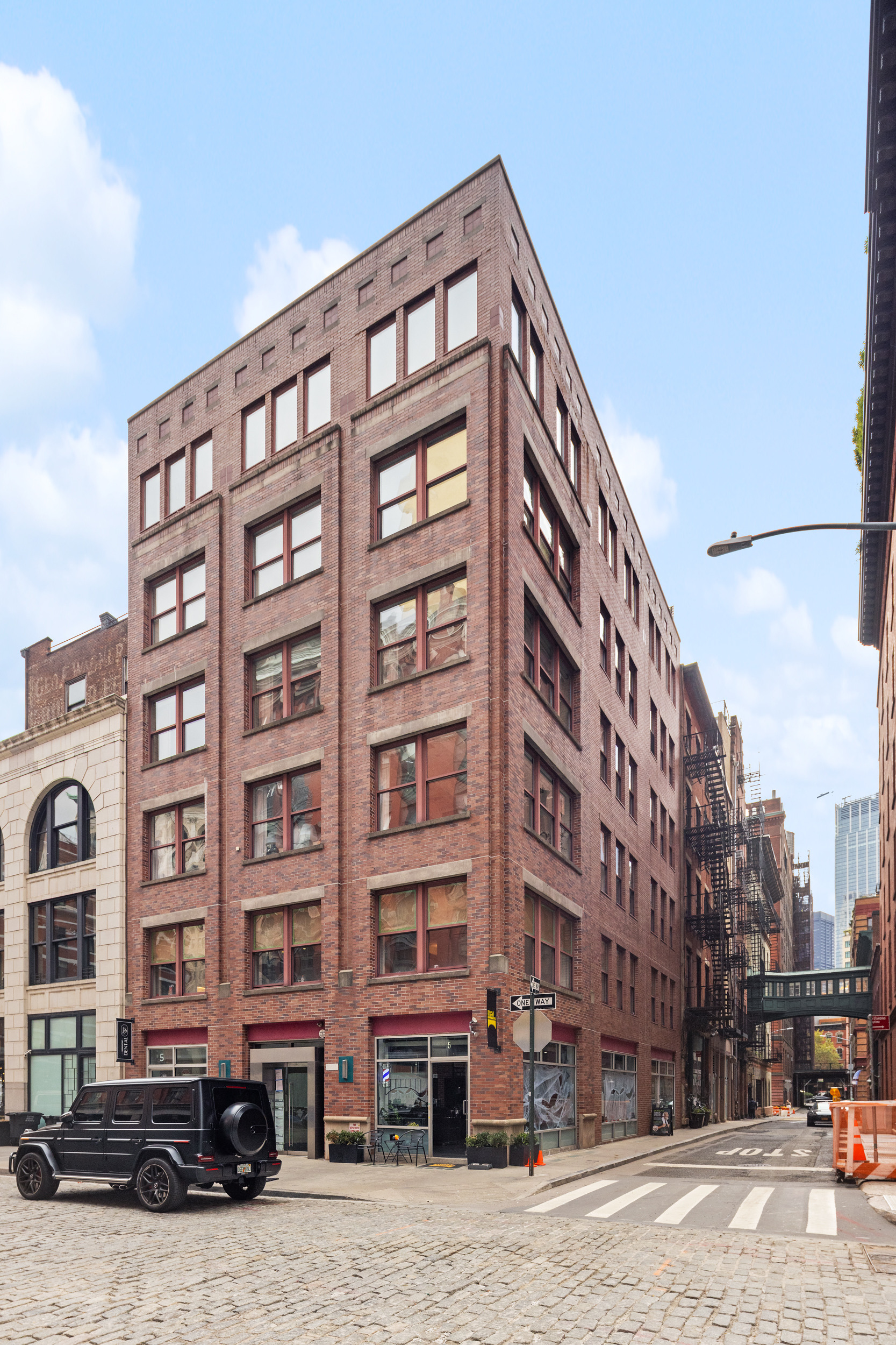 5 Harrison Street, Unit 3 Manhattan, NY 10013 - Photo 13 of 14 a front view of a building with lot of cars and trees