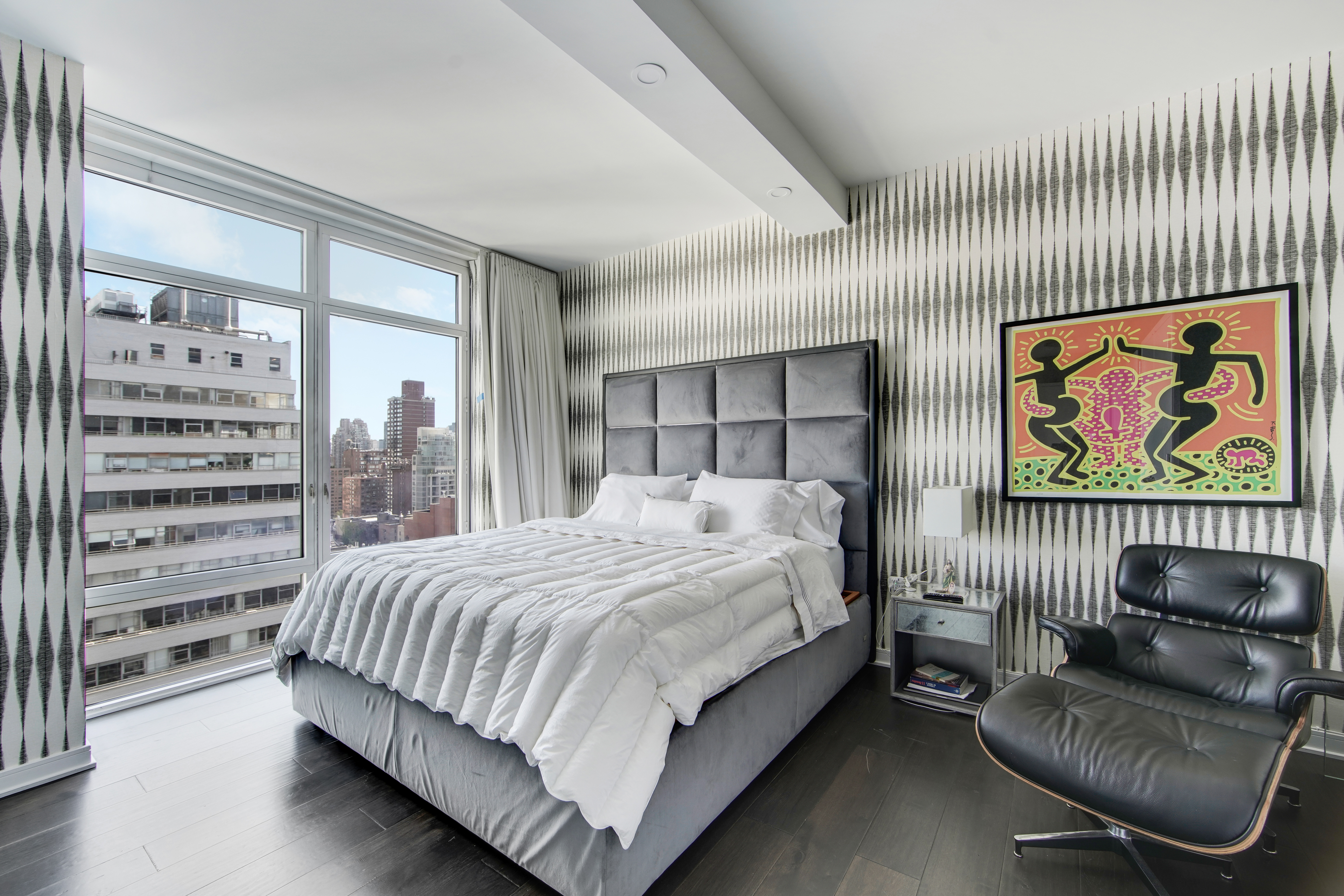 207 East 57th Street, Unit 20A Manhattan, NY 10022 - Photo 9 of 18 a bedroom with a bed and a large window