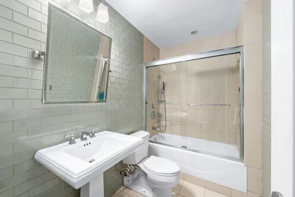 a bathroom with a sink mirror toilet and bathtub
