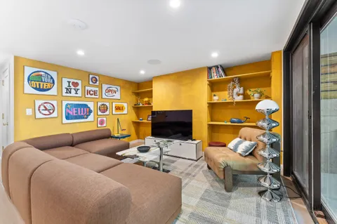 a bedroom with furniture and a flat screen tv