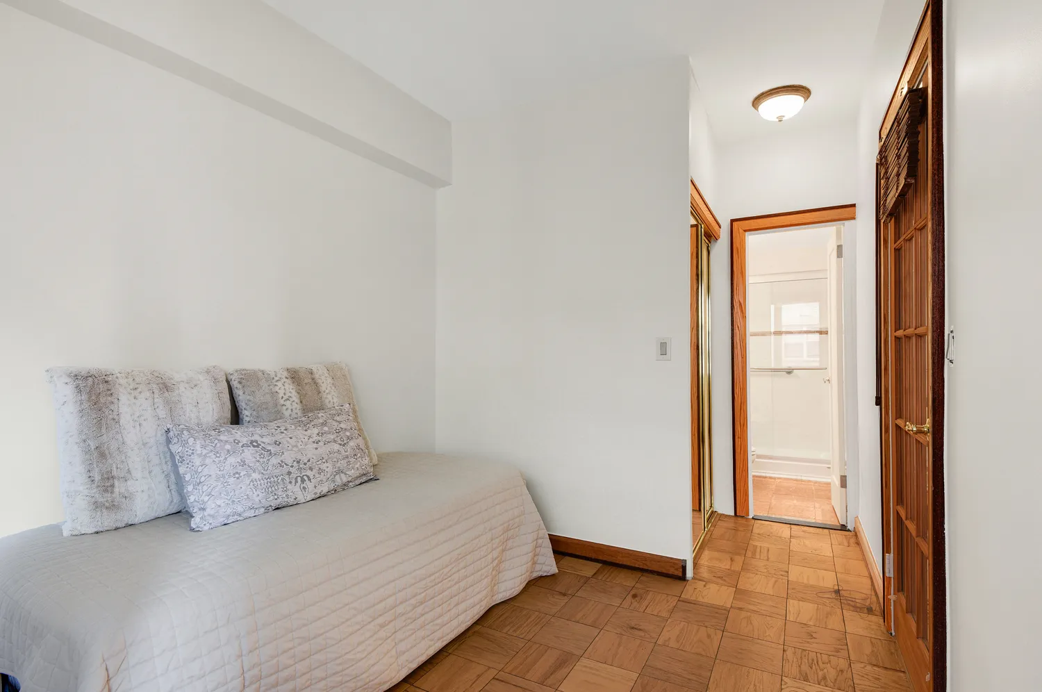 a room with a bed and a mirror