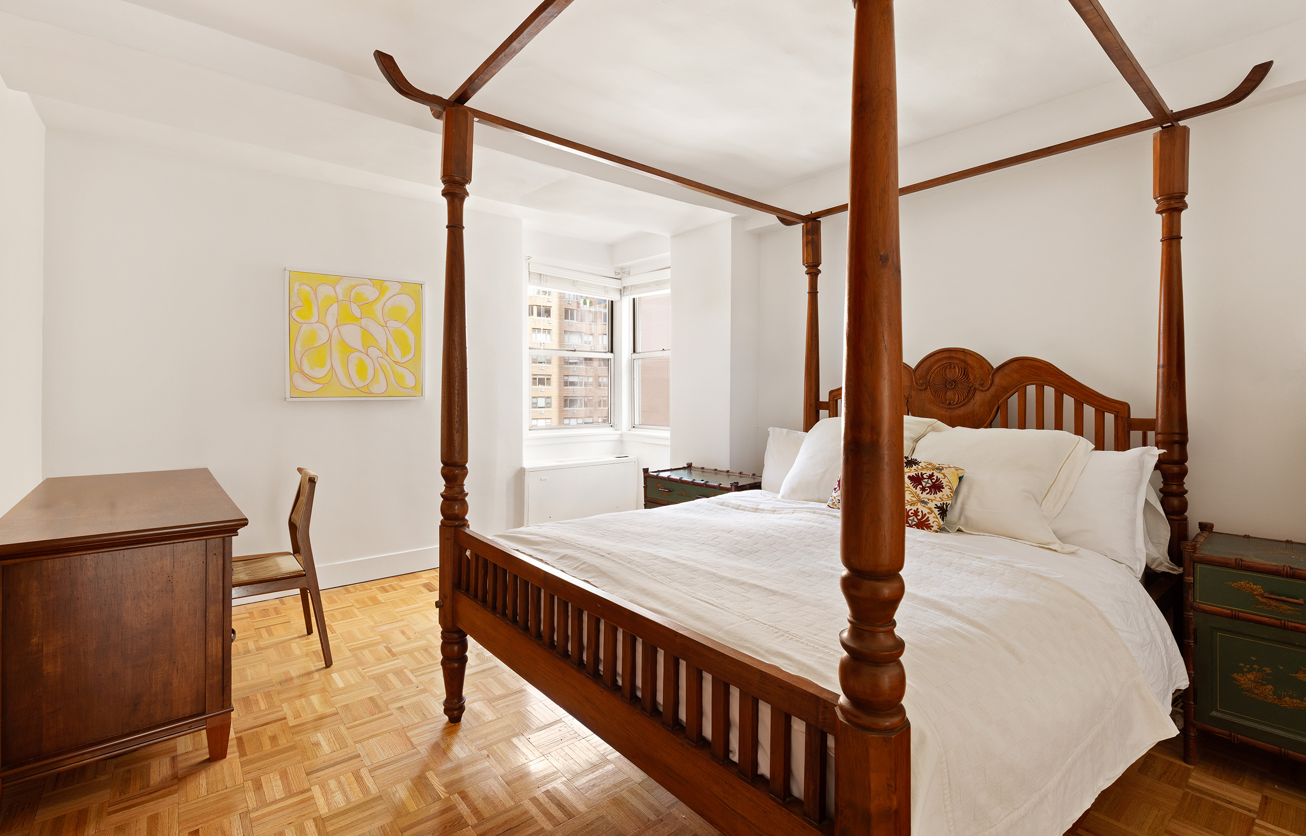 525 East 82nd Street, Unit 12E Manhattan, NY 10028 - Photo 18 of 29 a bedroom with a bed a table and chair