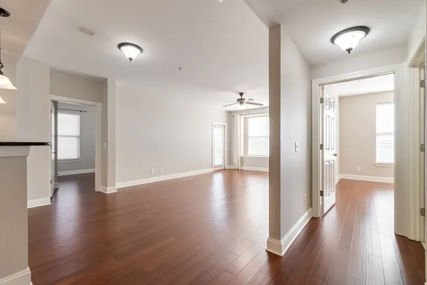 a view of a hallway with wooden floor