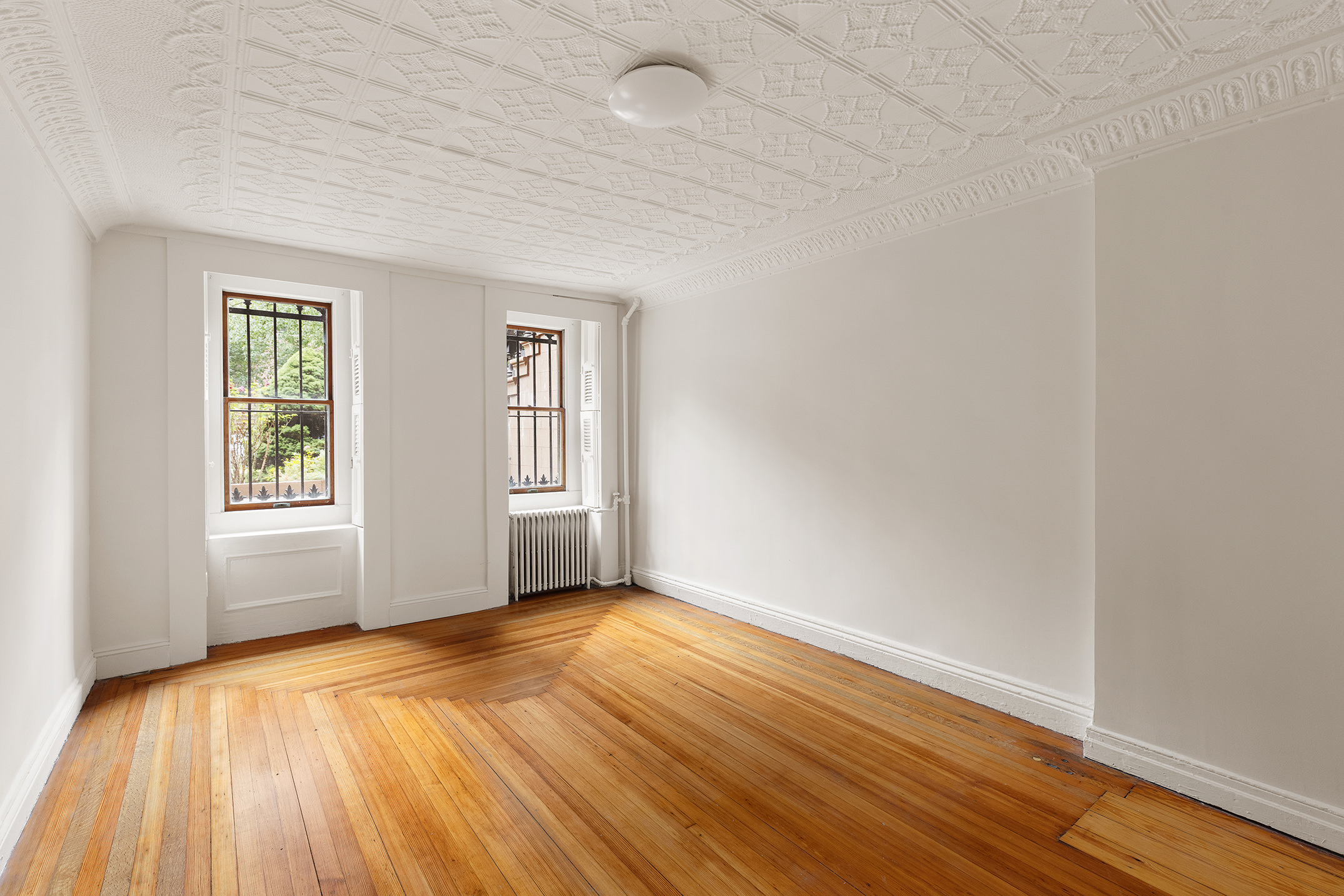 115 A 2nd Place Brooklyn, NY 11231 - Photo 21 of 27 an empty room with wooden floor and windows