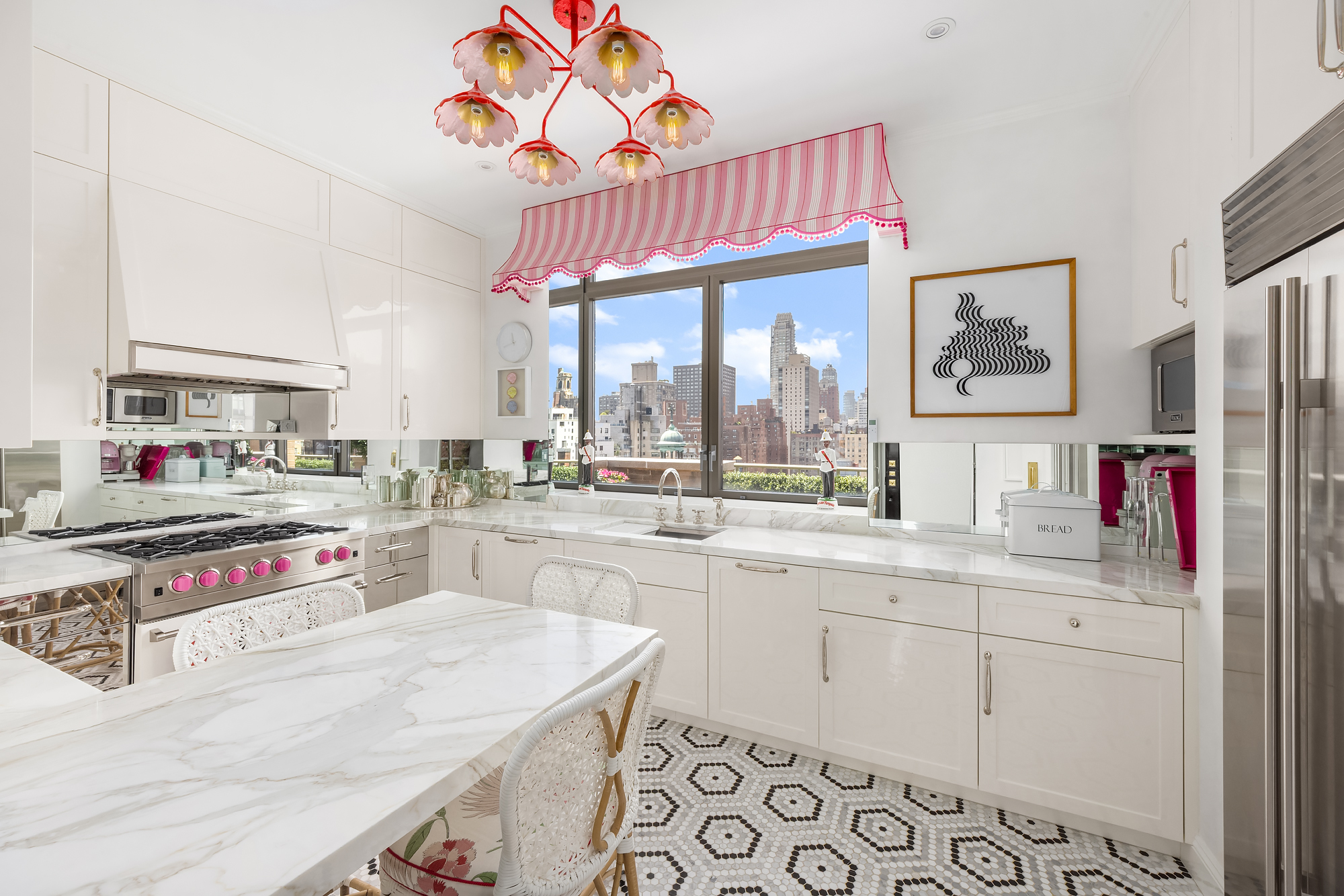 145 East 76th Street, Unit PH Manhattan, NY 10021 - Photo 7 of 19 a kitchen with stainless steel appliances granite countertop a sink dishwasher and cabinets with wooden floor