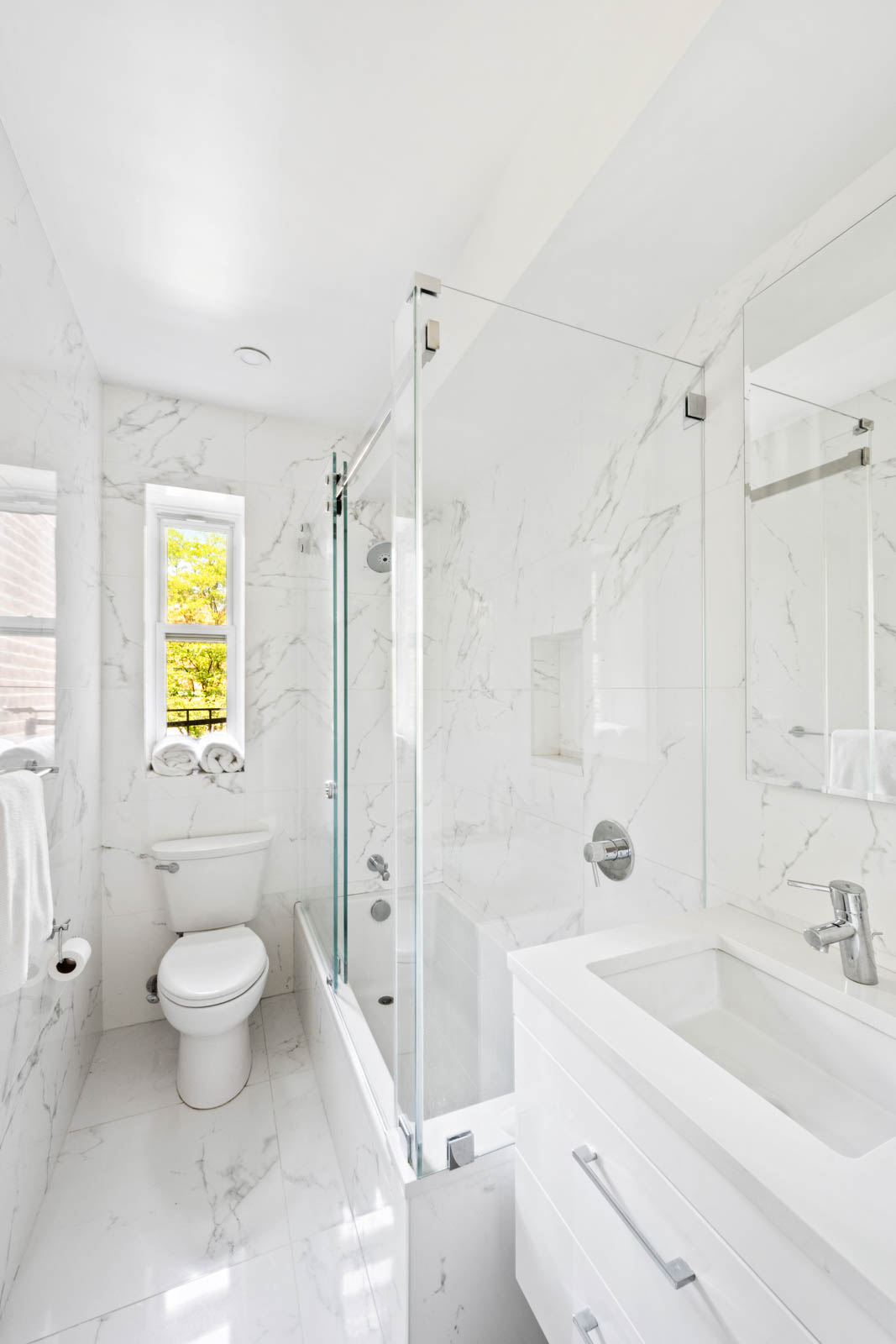 520 East 90th Street, Unit 3M Manhattan, NY 10128 - Photo 7 of 11 a bathroom with a sink a toilet and shower