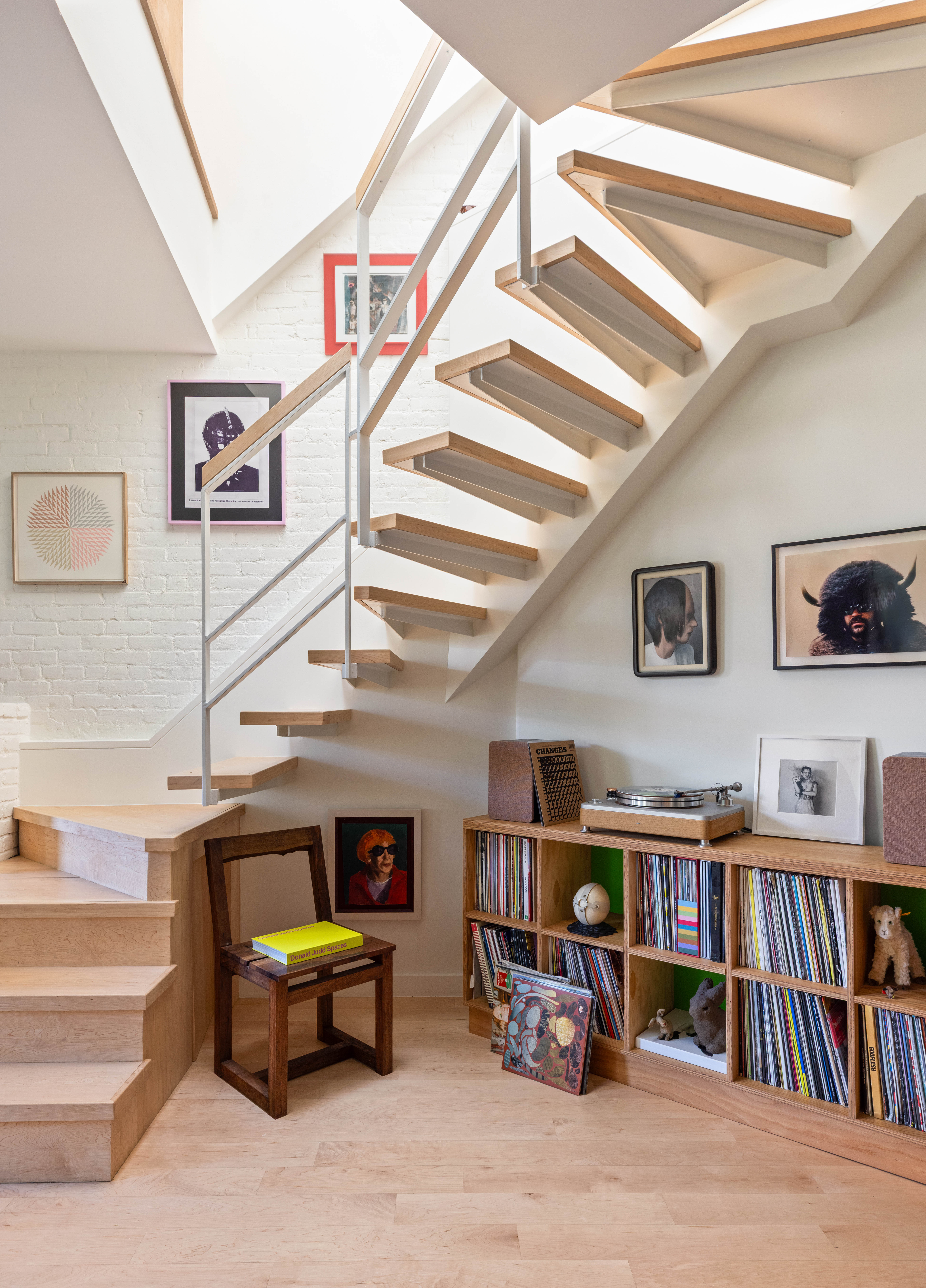 130 Jane Street, Unit 5/6F Manhattan, NY 10014 - Photo 9 of 23 a living room with lots of books and a book shelf