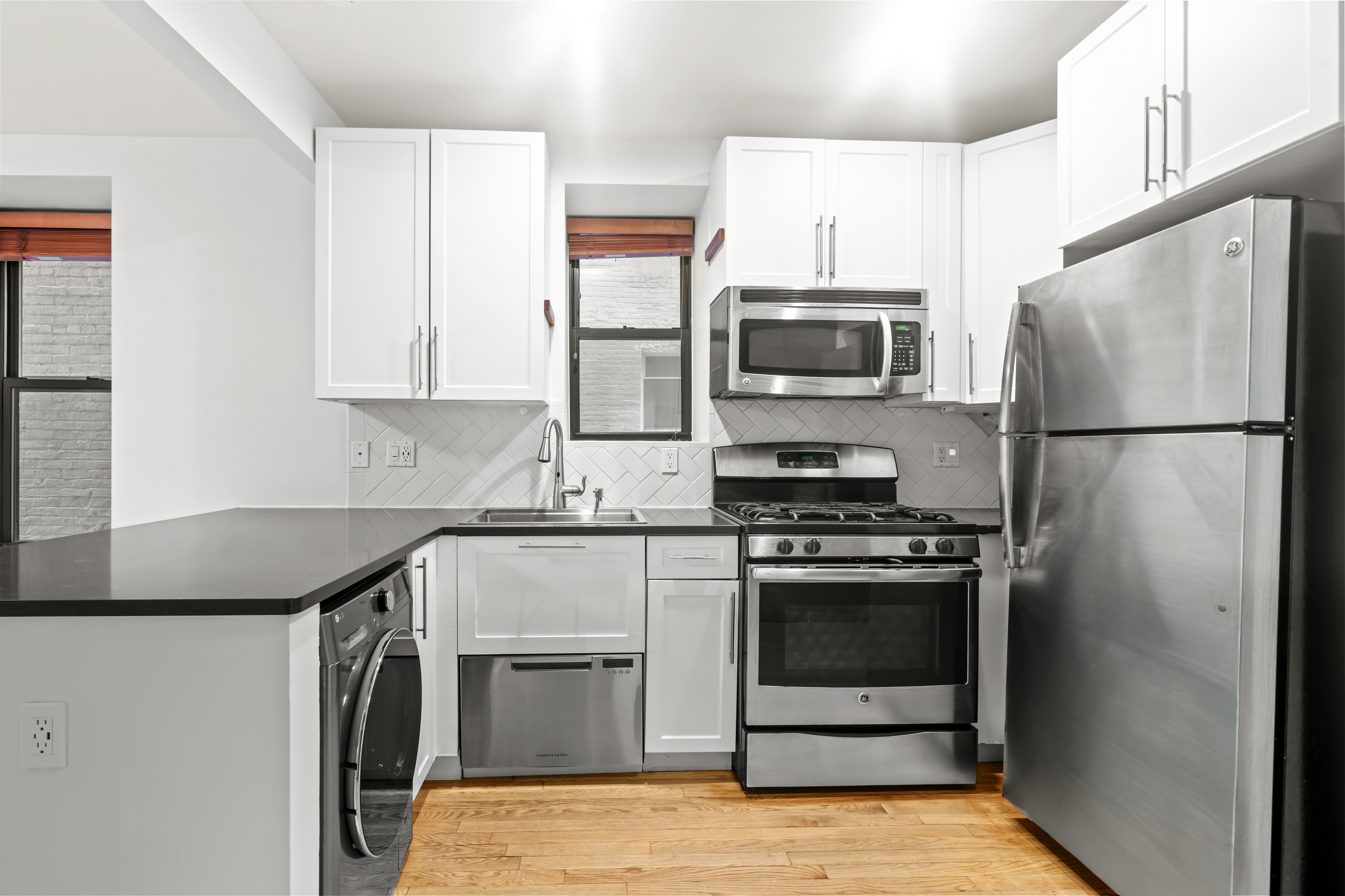 305 West 150th Street, Unit 206 Manhattan, NY 10039 - Photo 7 of 18 a kitchen with a stove a refrigerator and a microwave