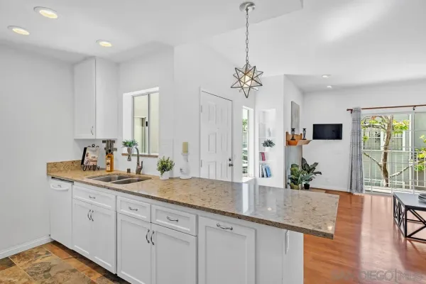 a view of living room with granite countertop furniture and floor to ceiling window