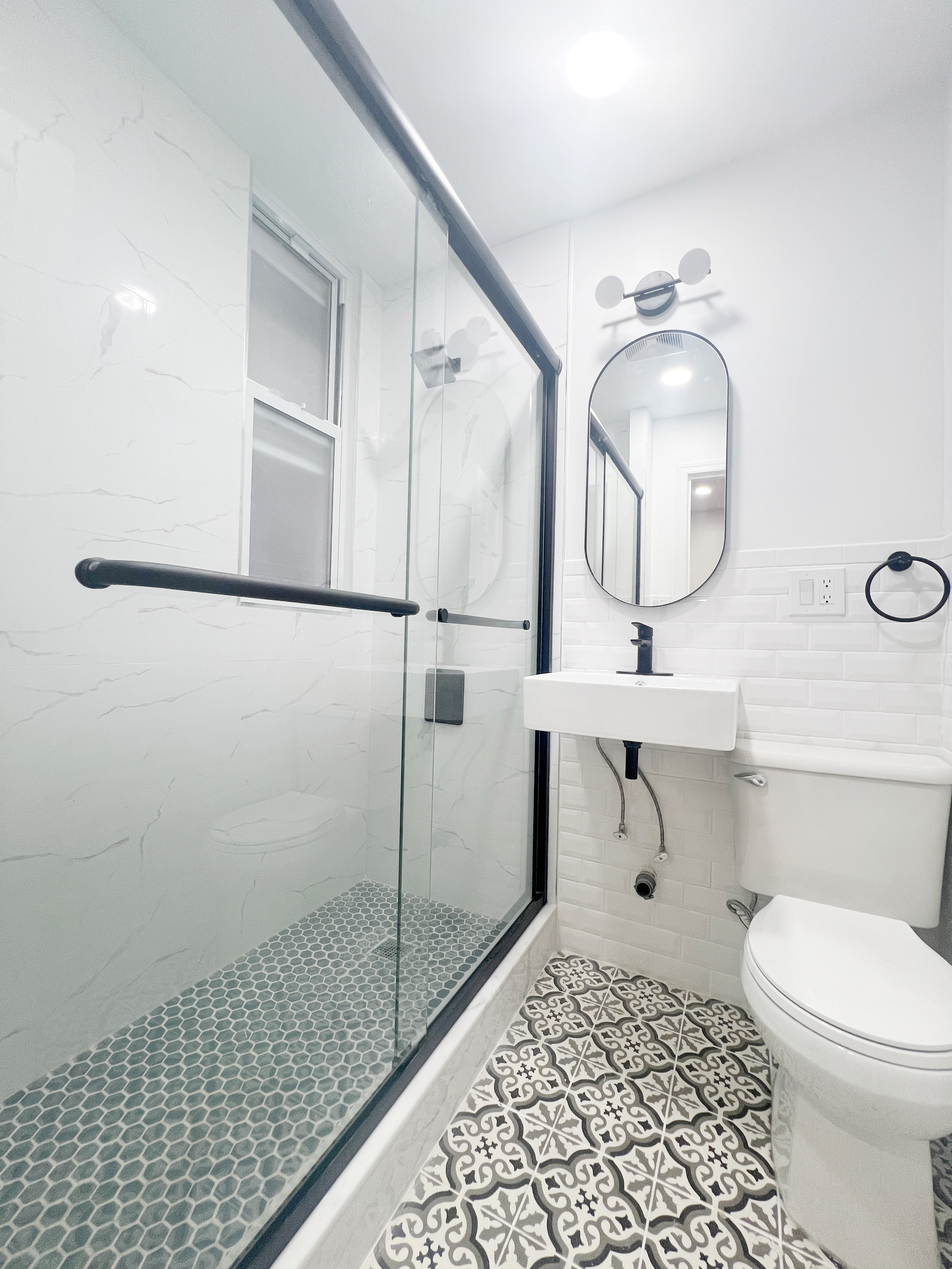 17-22 Menahan Street, Unit 1 Queens, NY 11385 - Photo 7 of 9 a bathroom with a sink a toilet and a mirror