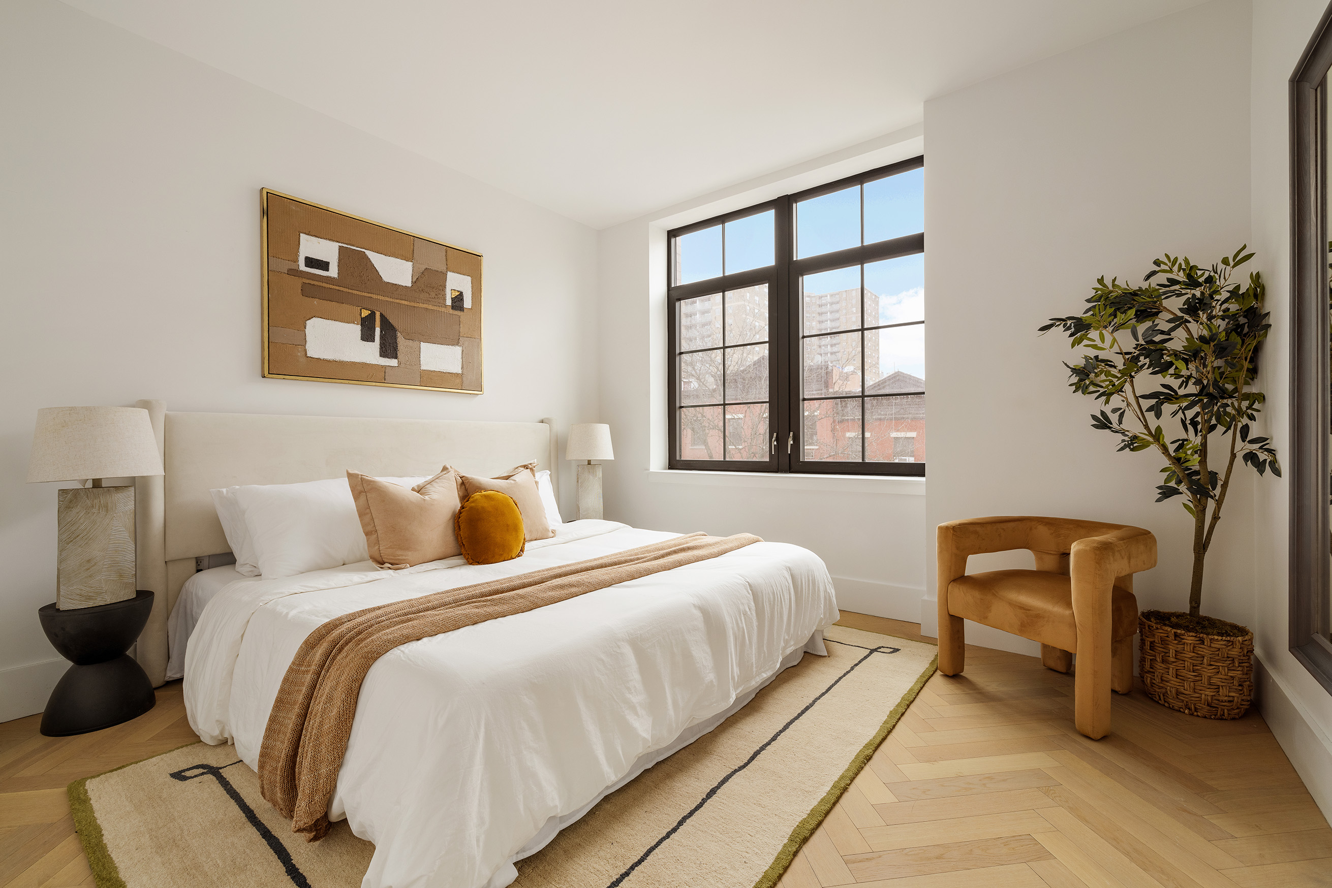 100 Avenue A, Unit 4B Manhattan, NY 10009 - Photo 5 of 11 a bedroom with bed and a potted plant