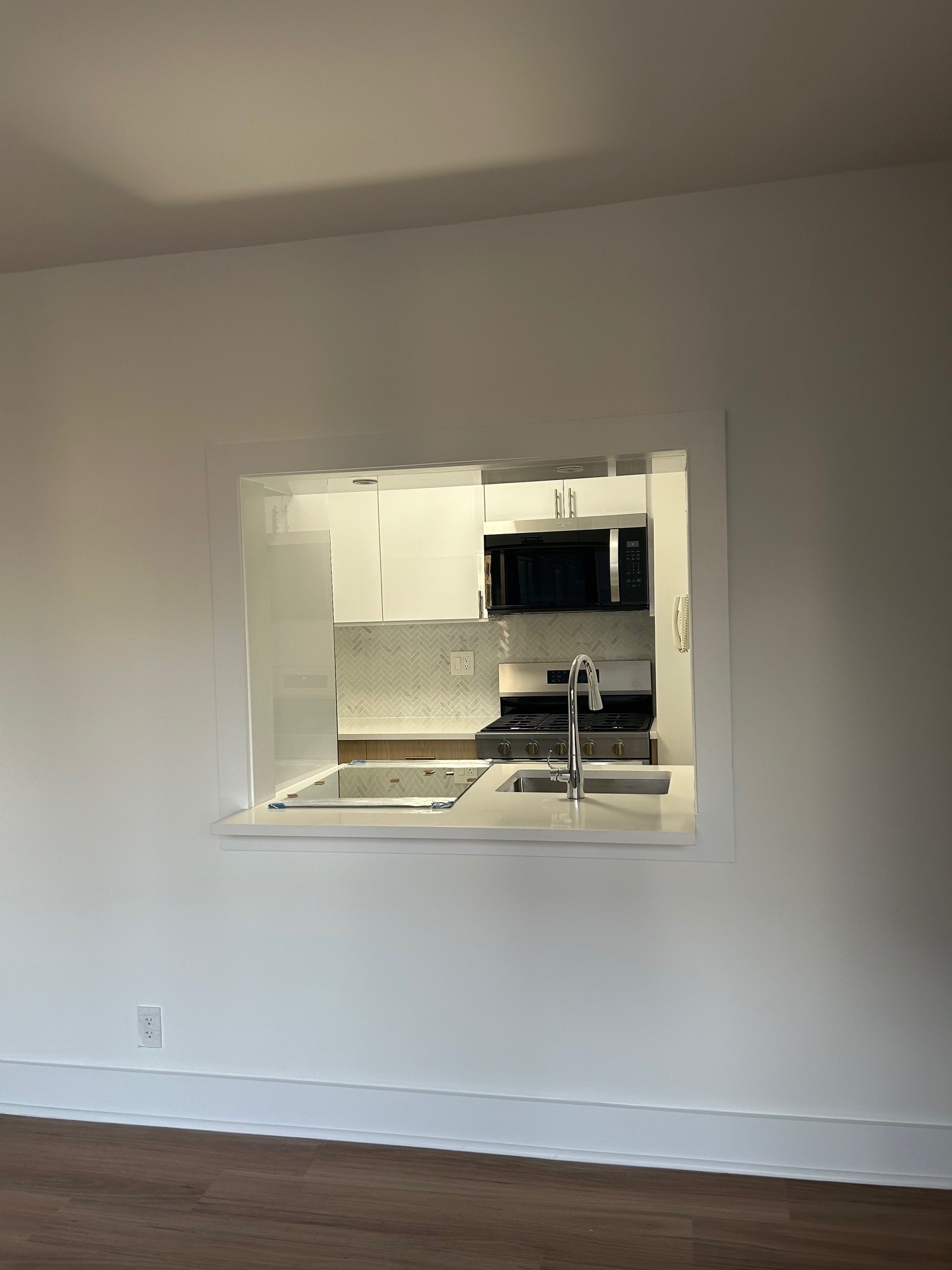400 East 54th Street, Unit 19H Manhattan, NY 10022 - Photo 13 of 19 a view of kitchen with microwave and stove