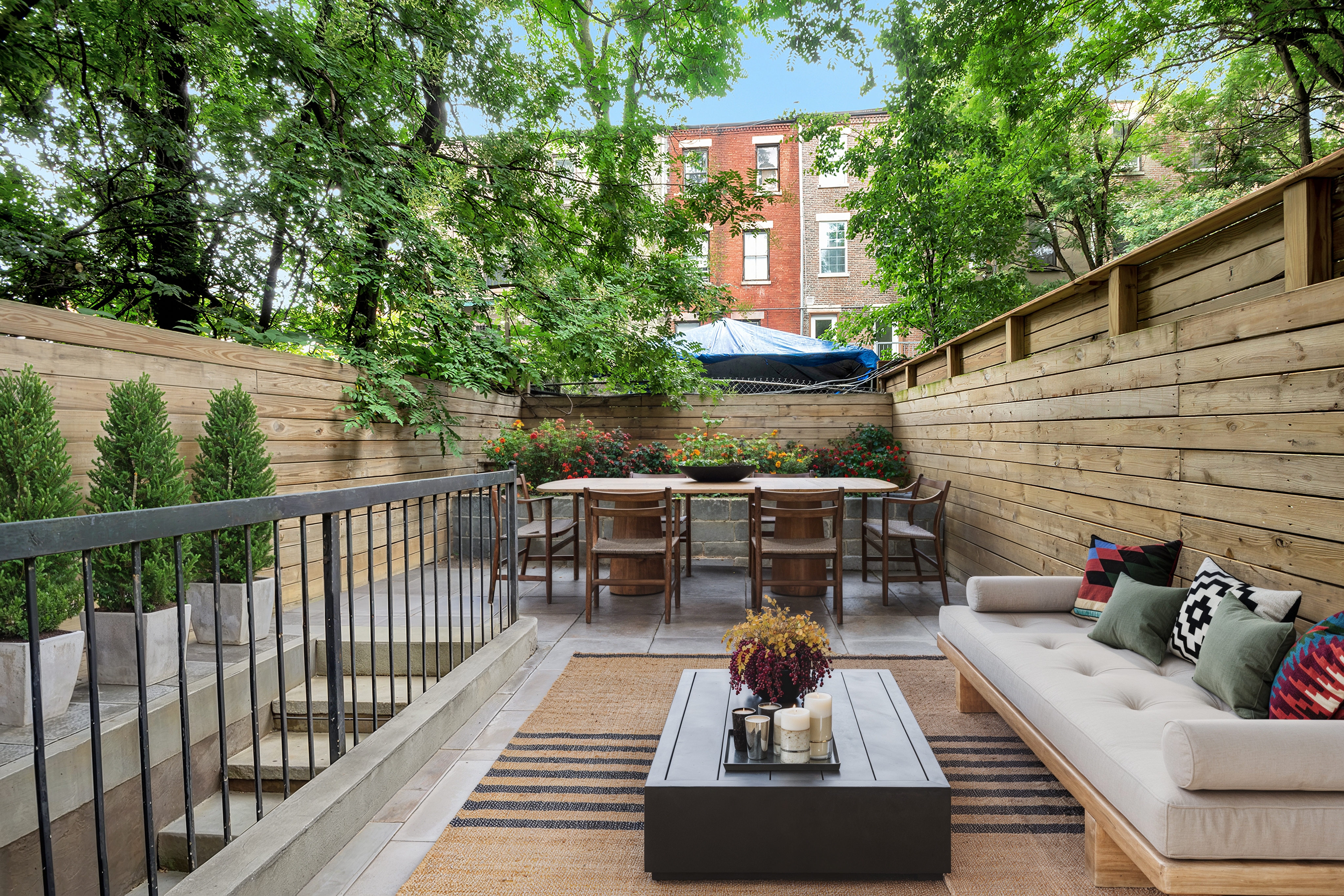 265 West 131st Street, Unit GARDEN Manhattan, NY 10027 - Photo 1 of 11 a view of a patio with couches table and chairs and potted plants
