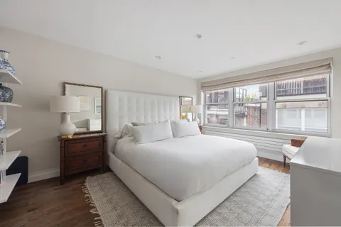 a bedroom with a large bed and a large window