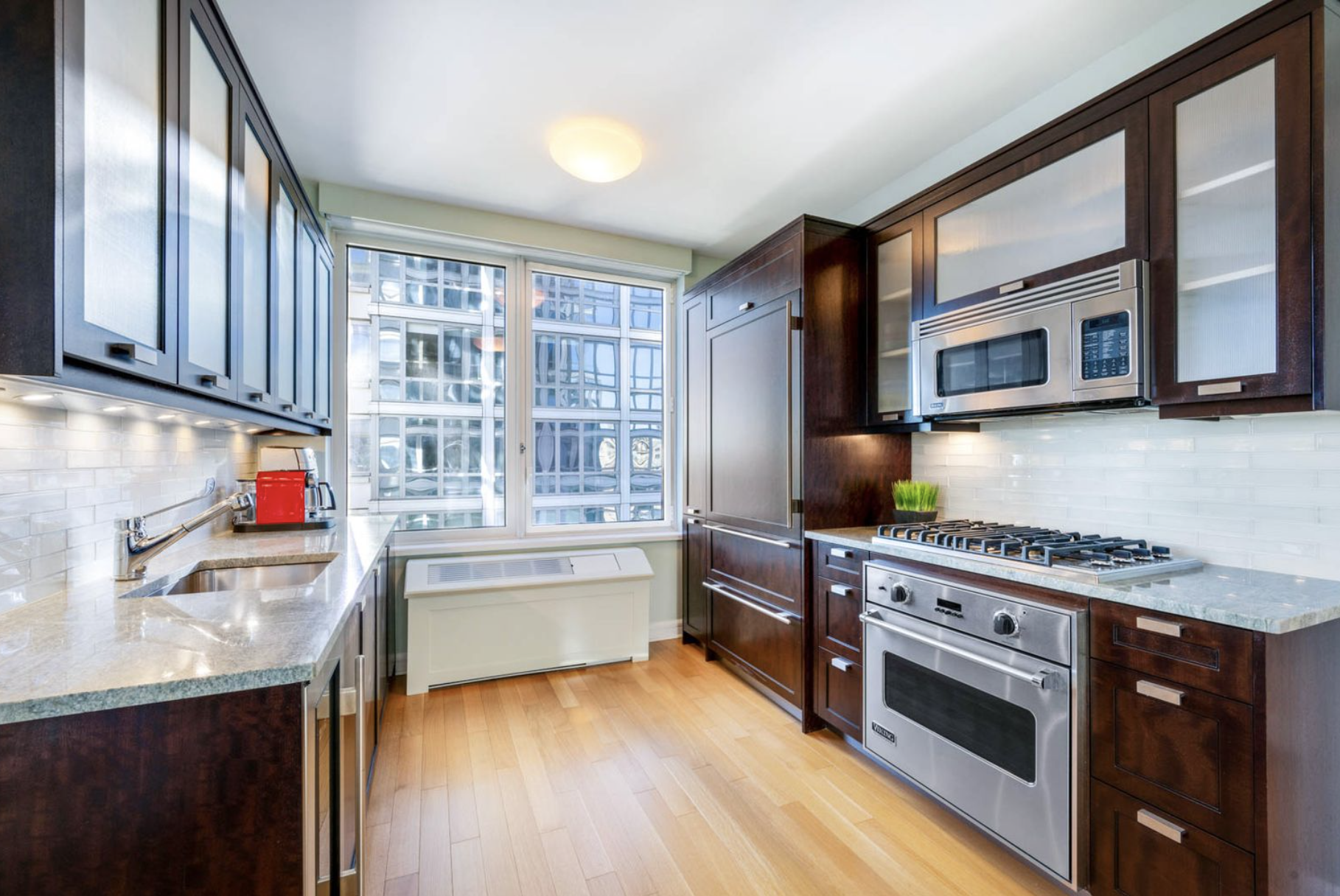 80 Riverside Boulevard, Unit 23C Manhattan, NY 10069 - Photo 6 of 19 a kitchen with stainless steel appliances granite countertop a stove and a sink