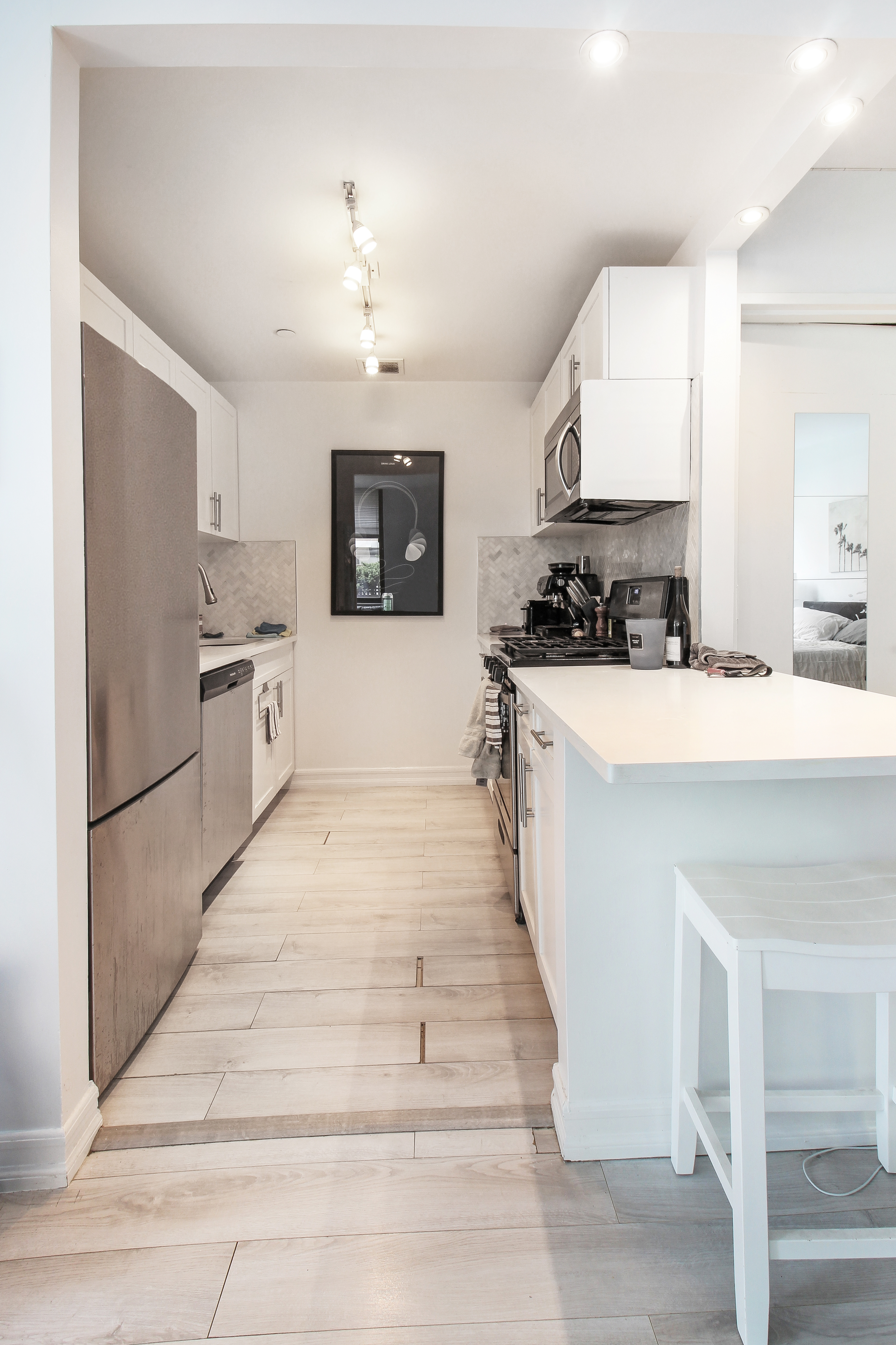 199 Bowery, Unit 2B Manhattan, NY 10002 - Photo 3 of 12 a large white kitchen with cabinets