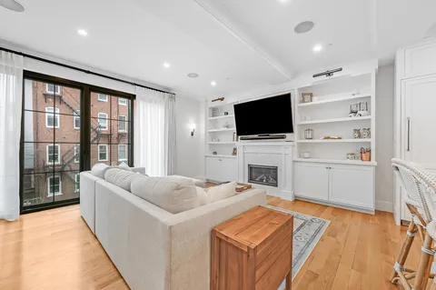 a living room with fireplace furniture and a flat screen tv