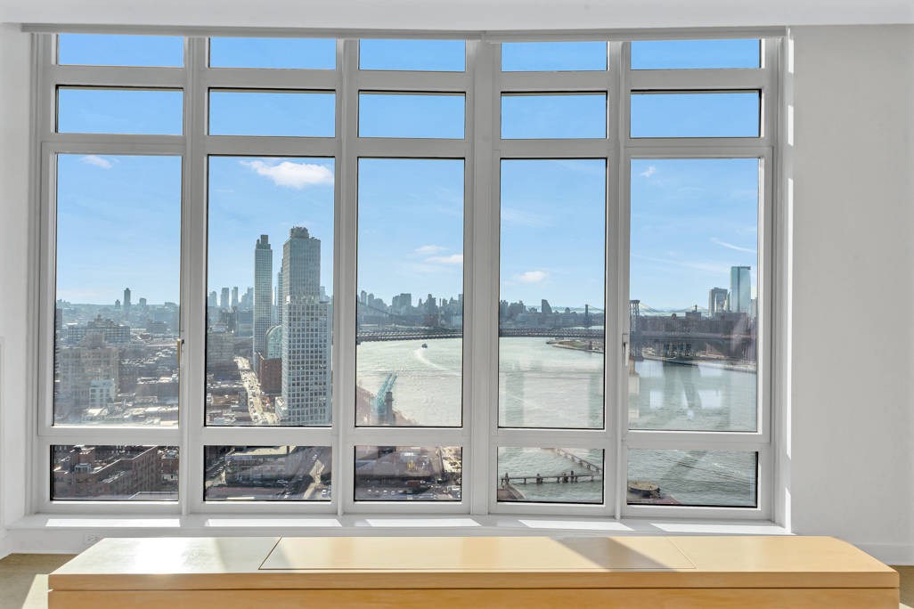 2 Northside Piers, Unit PH2 Brooklyn, NY 11249 - Photo 14 of 27 a living room with a large window and table