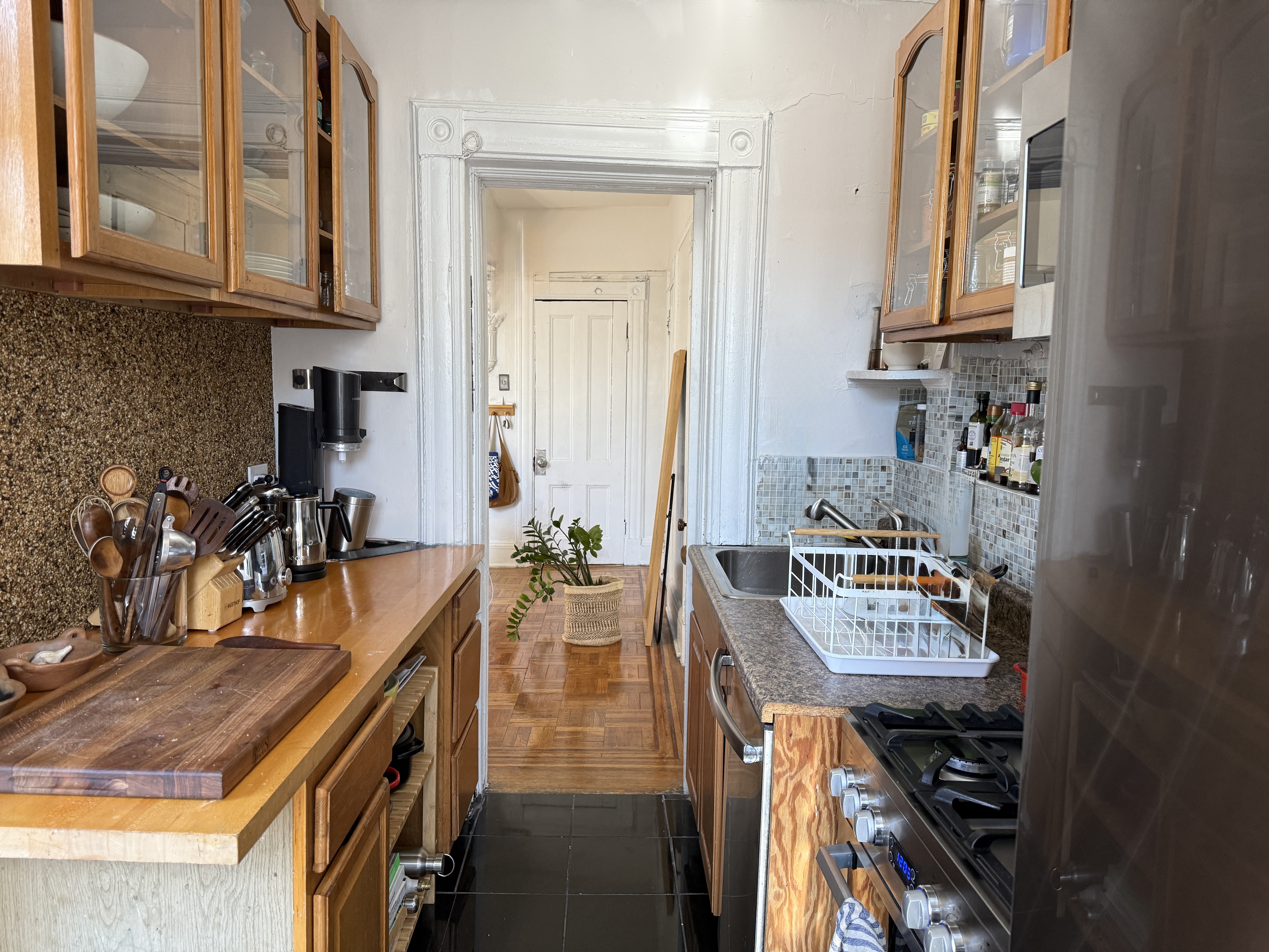 814 Putnam Avenue, Unit 2 Brooklyn, NY 11221 - Photo 3 of 8 a kitchen with stainless steel appliances granite countertop a sink stove and cabinets