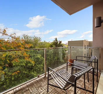 a view of a balcony with two chairs