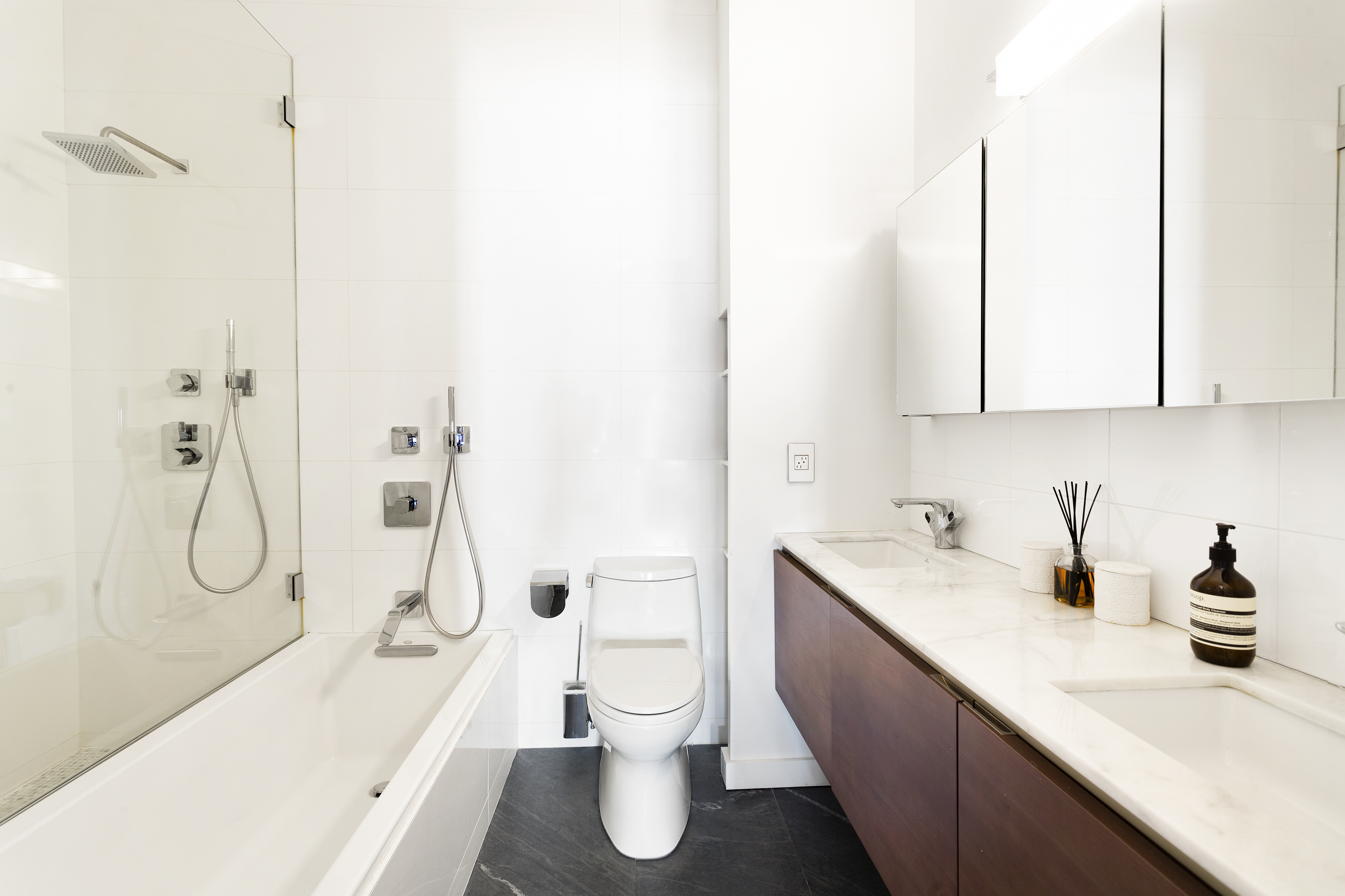 272 Water Street, Unit 5F Manhattan, NY 10038 - Photo 9 of 12 a bathroom with a sink a toilet and a bathtub