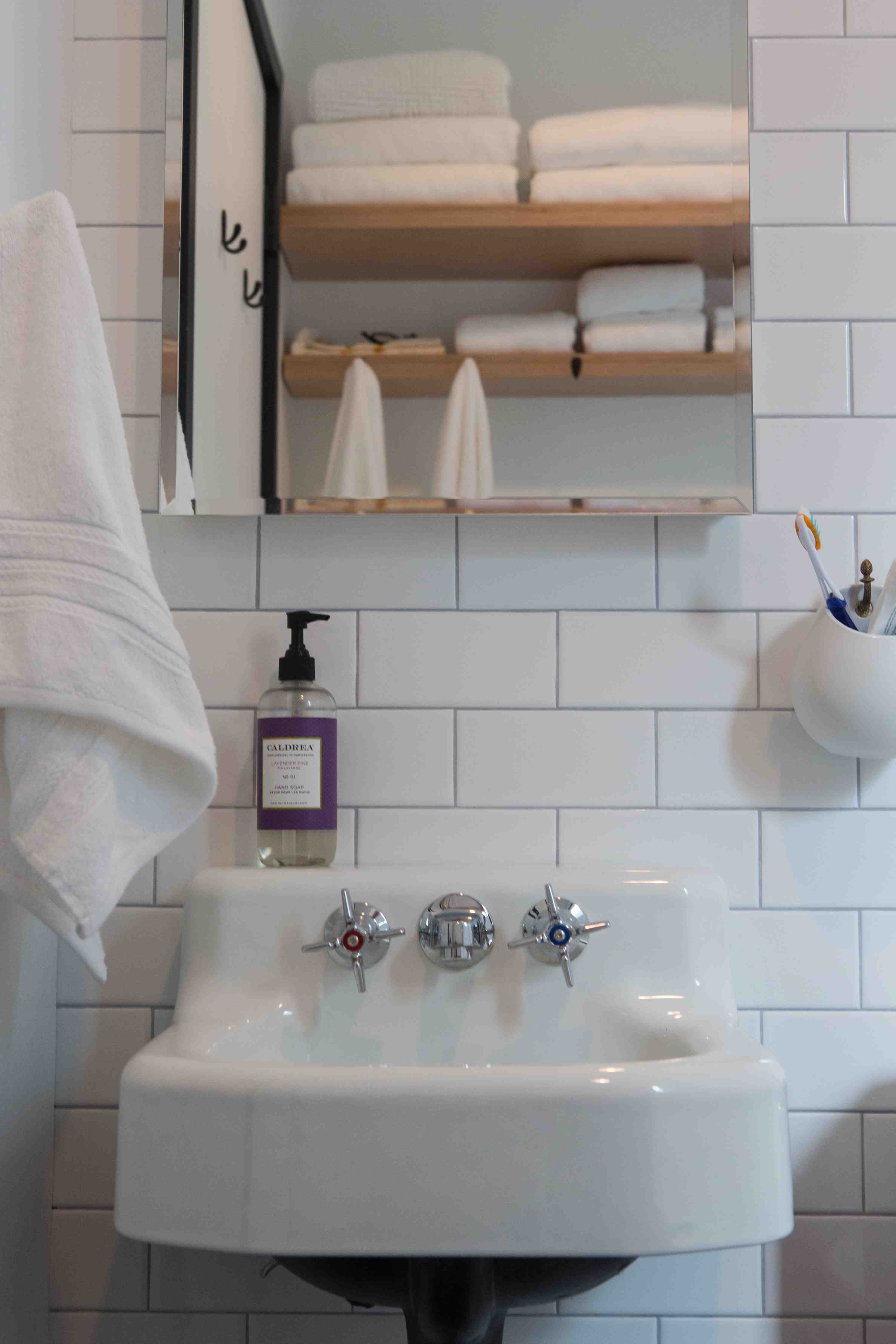 162 10th Street Brooklyn, NY 11215 - Photo 11 of 13 a bathroom with a sink and a mirror