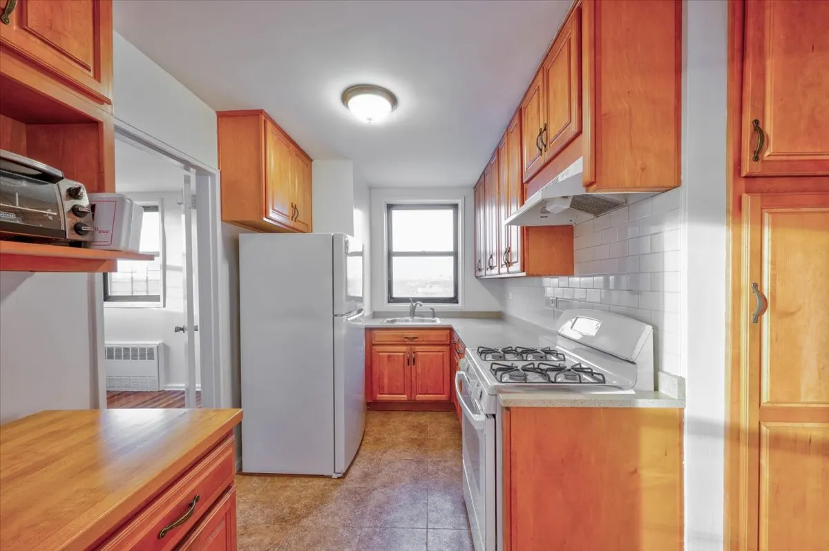 a kitchen with stainless steel appliances granite countertop a refrigerator and a stove