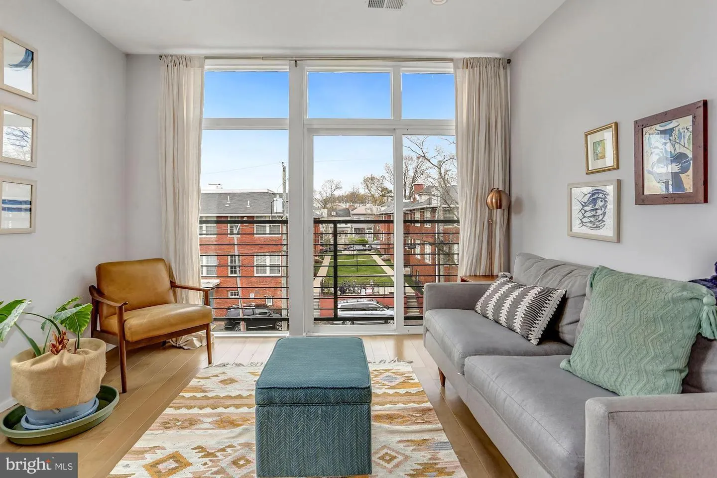 a living room with furniture and a floor to ceiling window