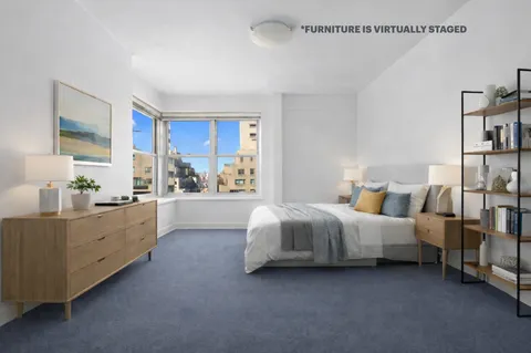 a view of a big room with closet and windows