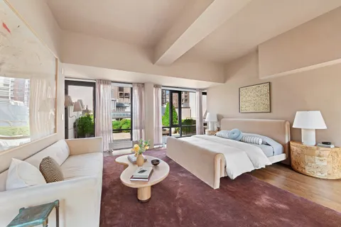 a spacious bedroom with a bed and a couch