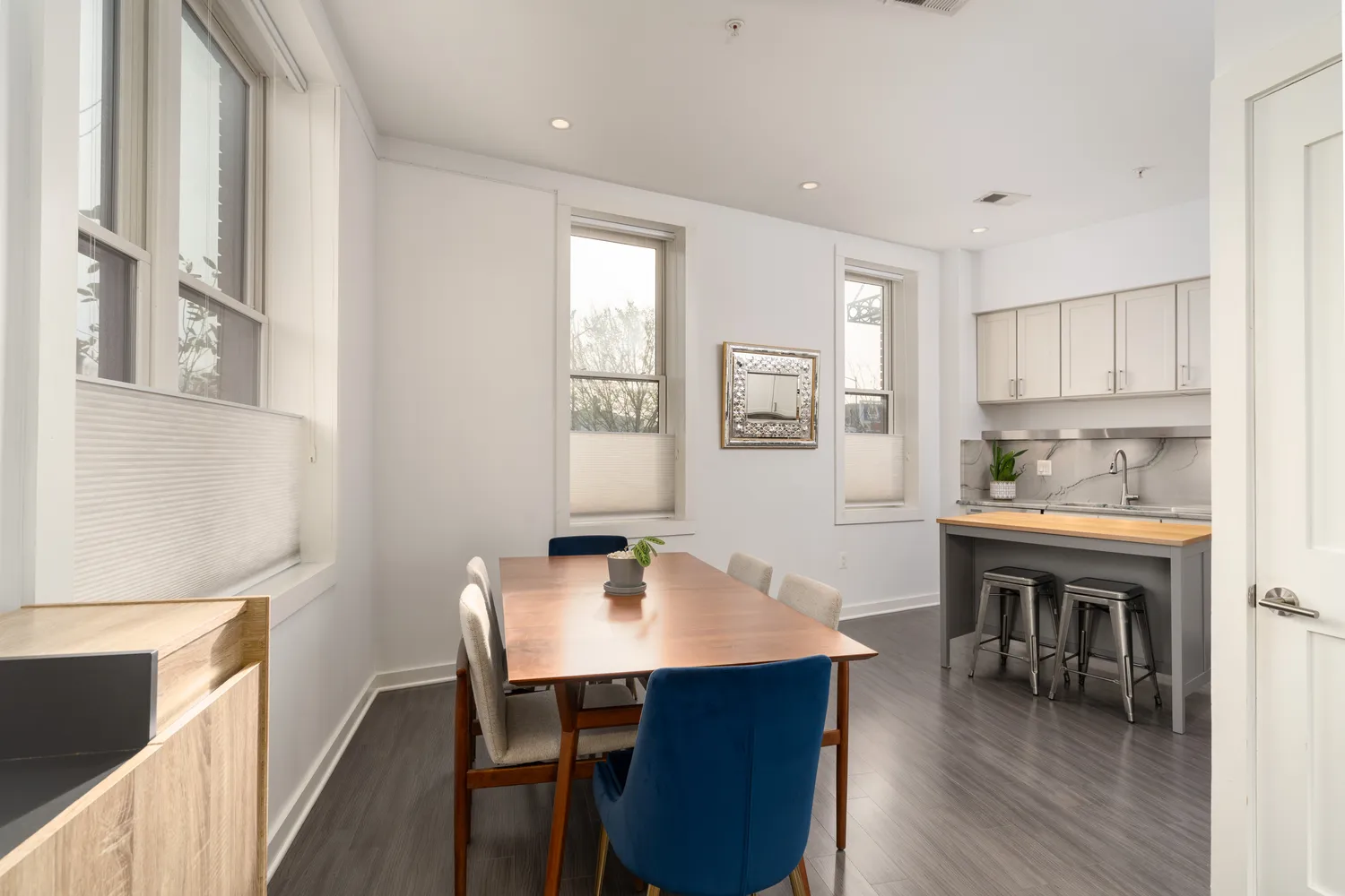 a view of a dining room with furniture and wooden floor