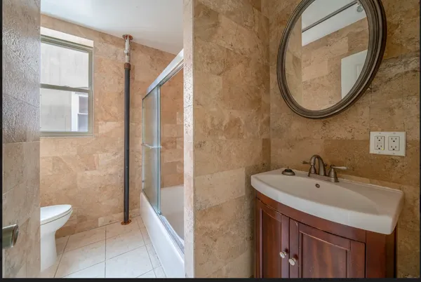 a bathroom with a sink a toilet and a mirror