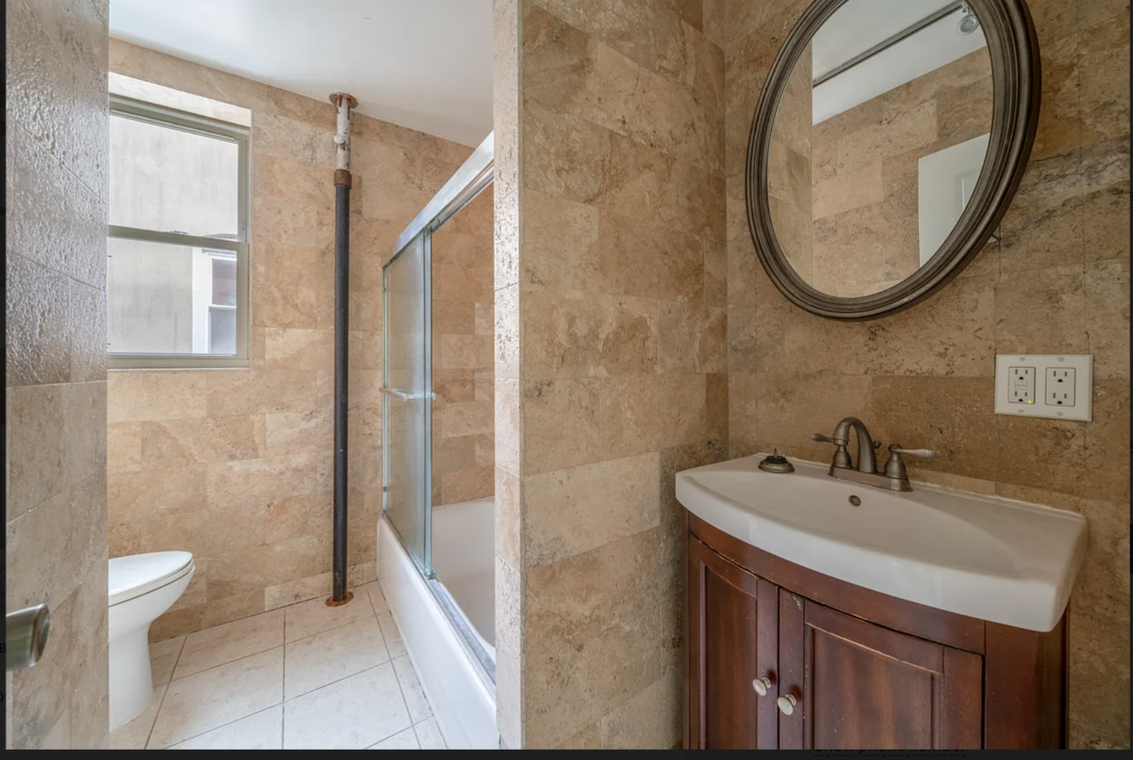 96 East 32nd Street, Unit 2 Brooklyn, NY 11226 - Photo 5 of 6 a bathroom with a sink a toilet and a mirror