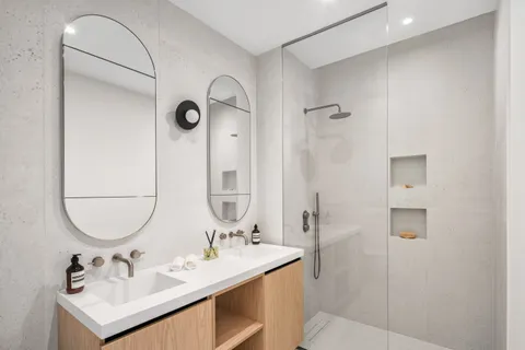 a bathroom with a sink vanity tub and a mirror
