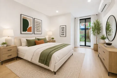 a spacious bedroom with a bed a mirror and a window