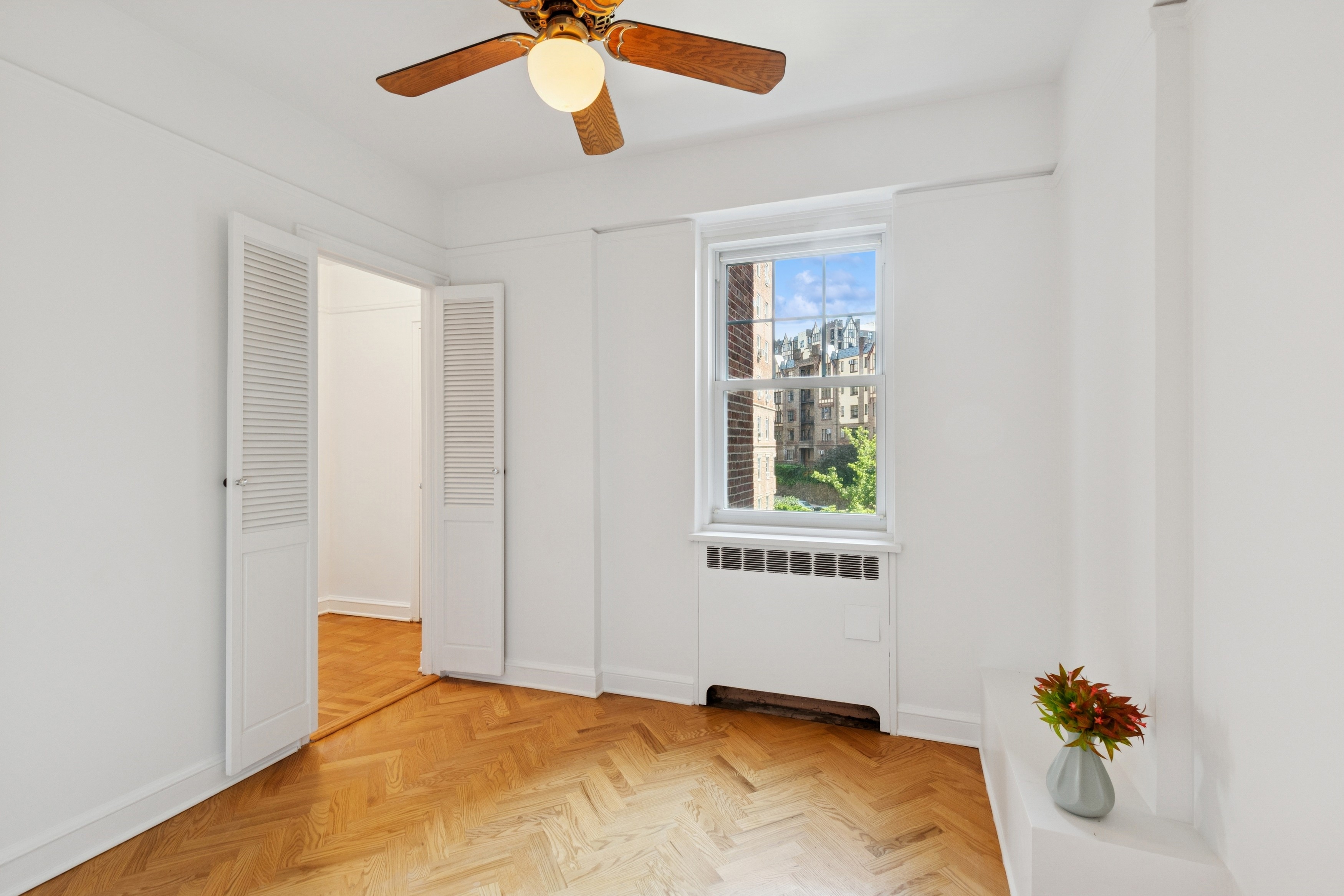 120 Cabrini Boulevard, Unit 48 Manhattan, NY 10033 - Photo 7 of 23 a bedroom with a bed and a chandelier