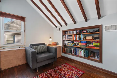 a living room with furniture and a book shelf