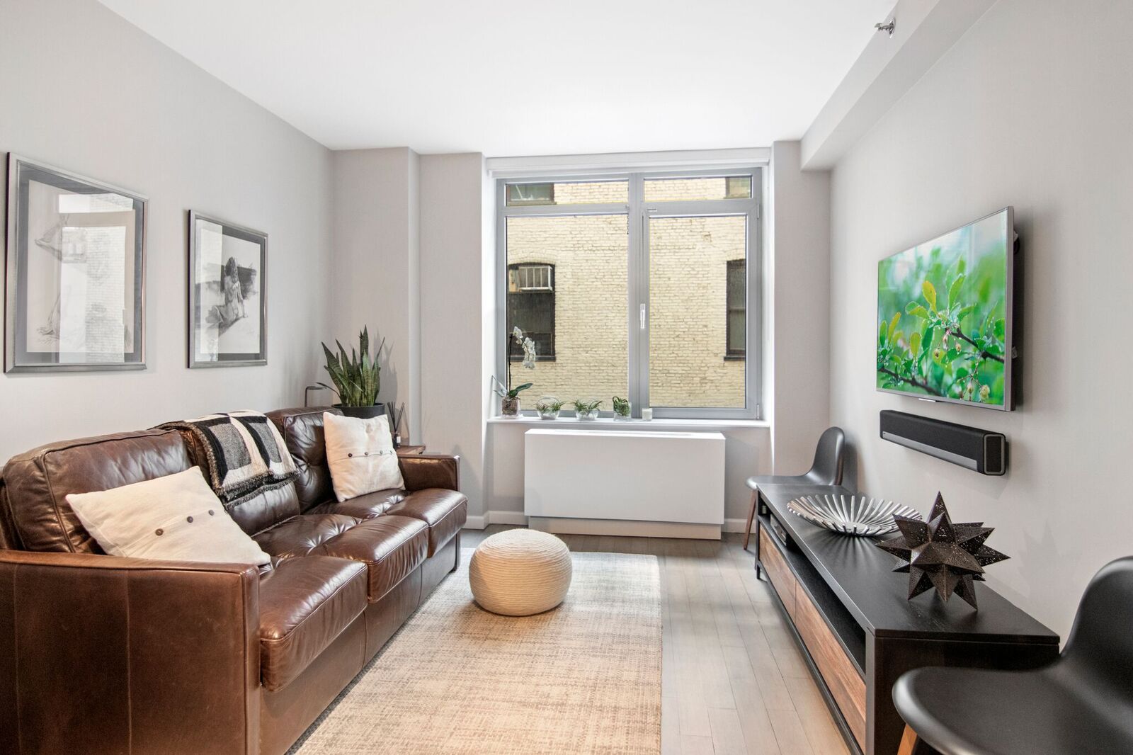 224 West 18th Street, Unit 6C Manhattan, NY 10011 - Photo 13 of 21 a living room with furniture and a large window