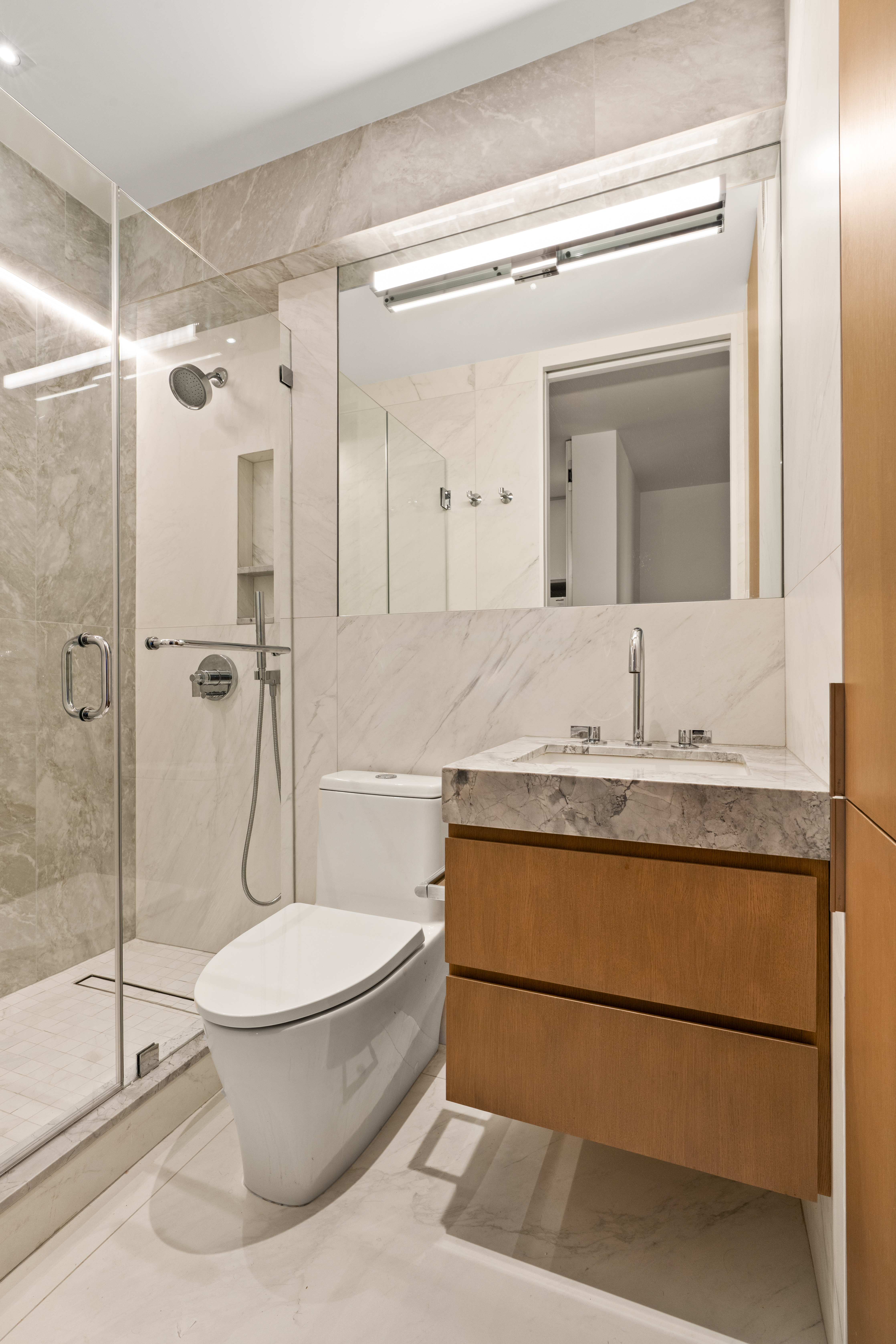 303 East 57th Street, Unit 44G Manhattan, NY 10022 - Photo 14 of 19 a bathroom with a sink toilet and shower