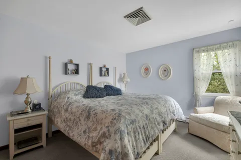 a bedroom with a bed and a couch