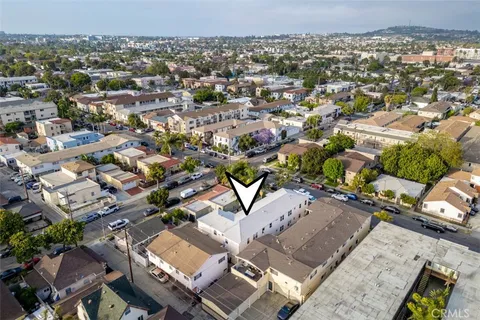 an aerial view of a residential houses with yard