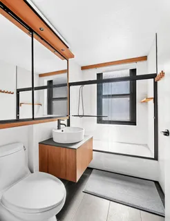 a bathroom with a sink a toilet and a window