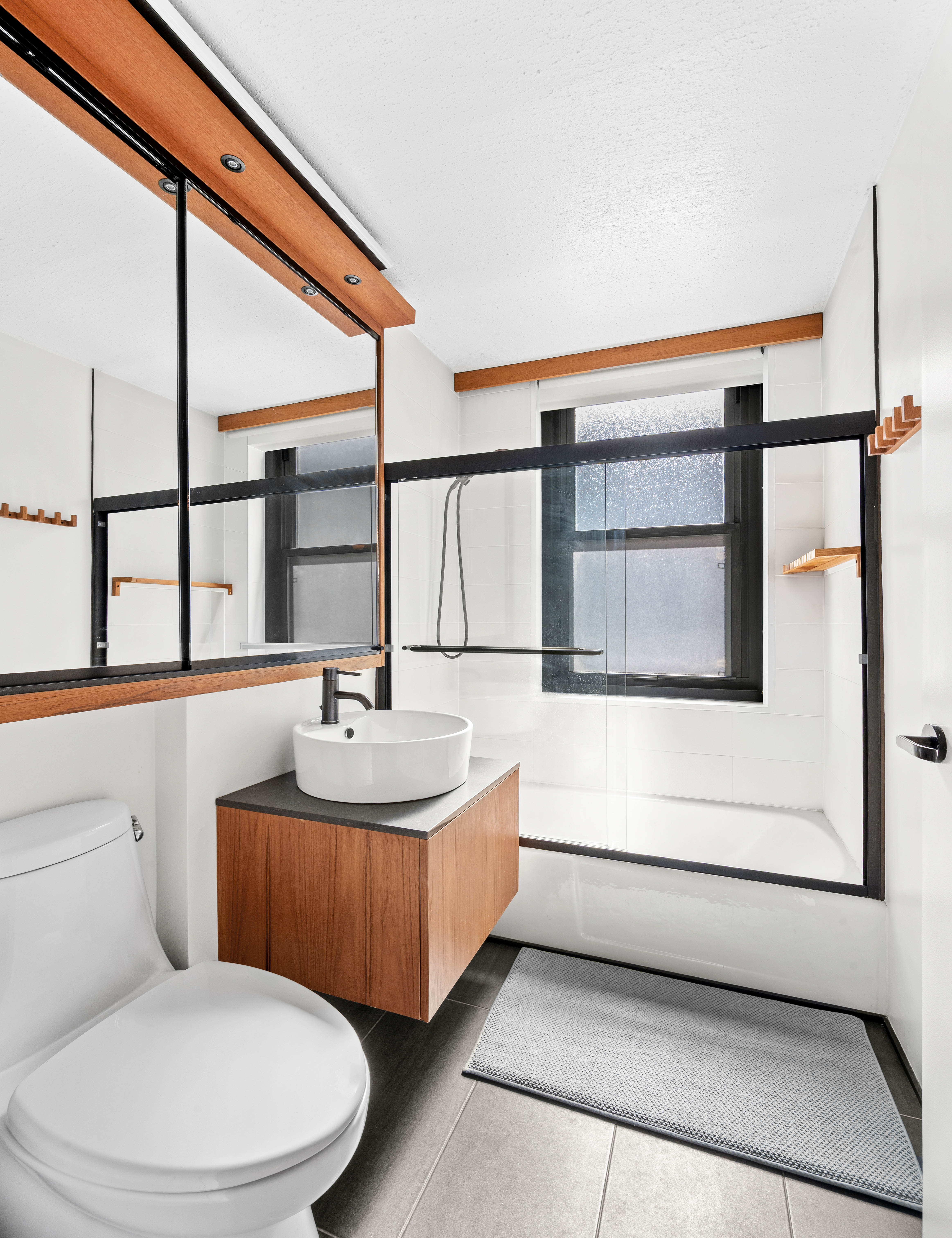 2025 Broadway, Unit 3A Manhattan, NY 10023 - Photo 5 of 8 a bathroom with a sink a toilet and a window