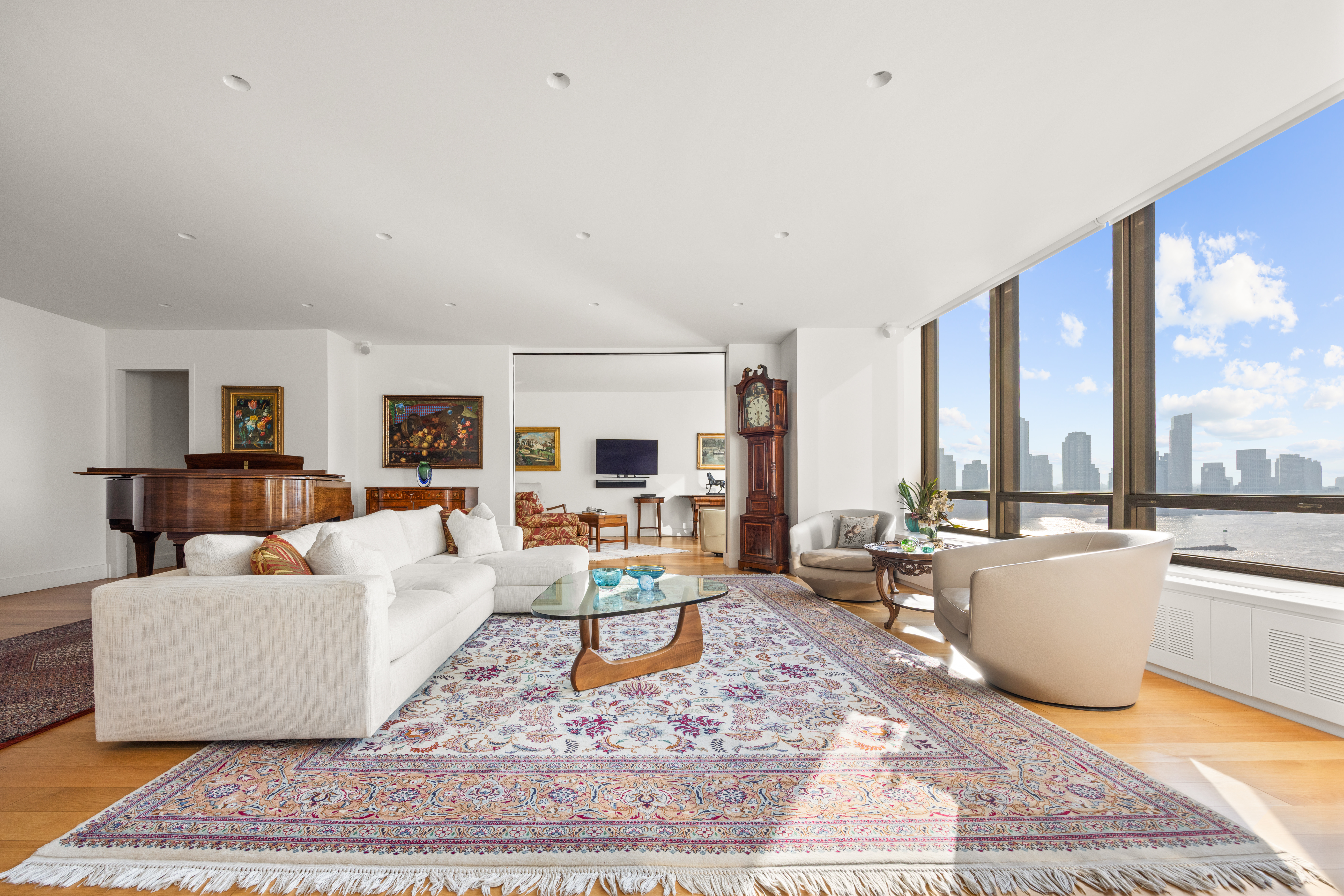 860 United Nations Plaza, Unit 16G Manhattan, NY 10017 - Photo 2 of 12 a living room with furniture and a rug