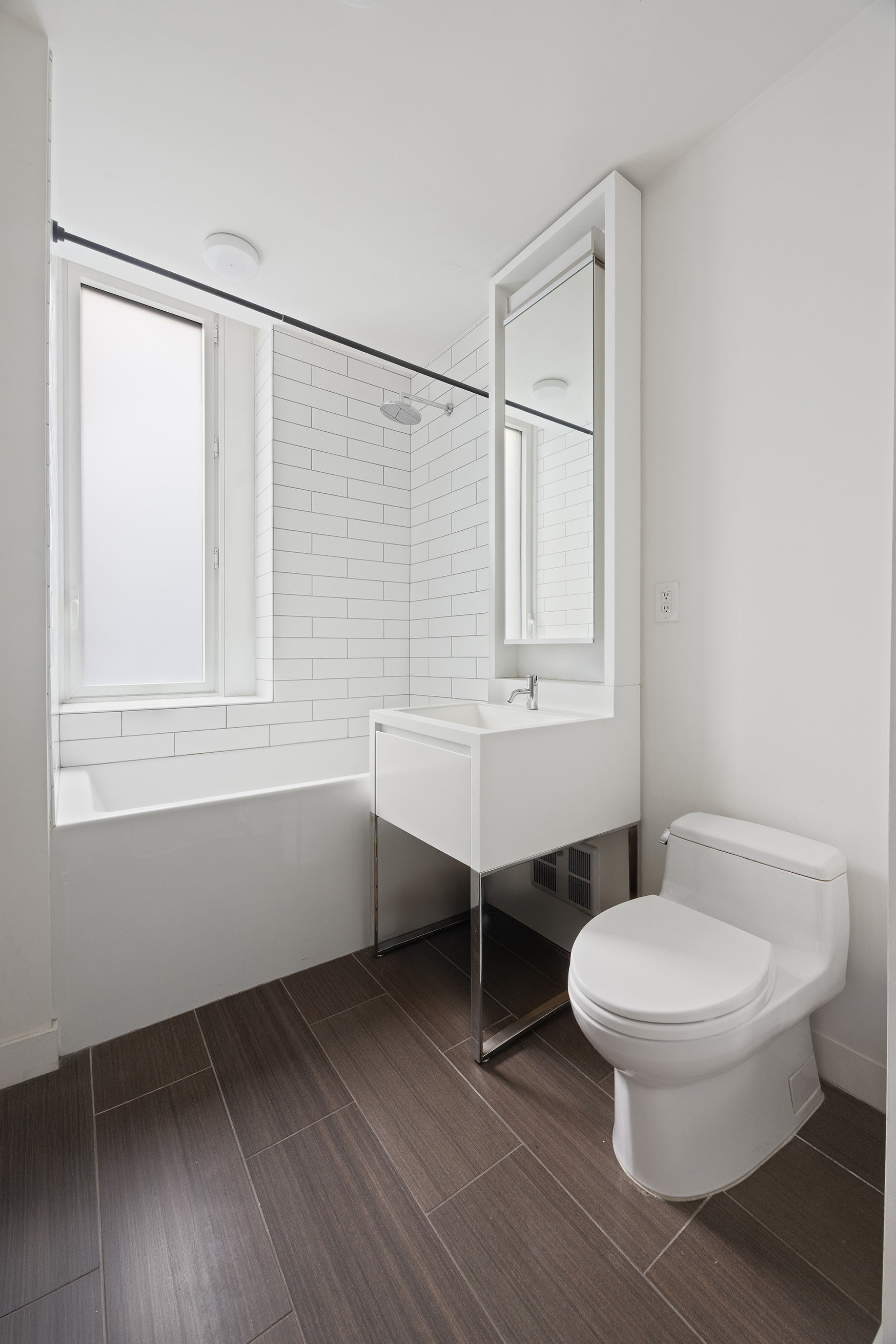 15 William Street, Unit 21A Manhattan, NY 10005 - Photo 8 of 19 a bathroom with a toilet a sink and mirror