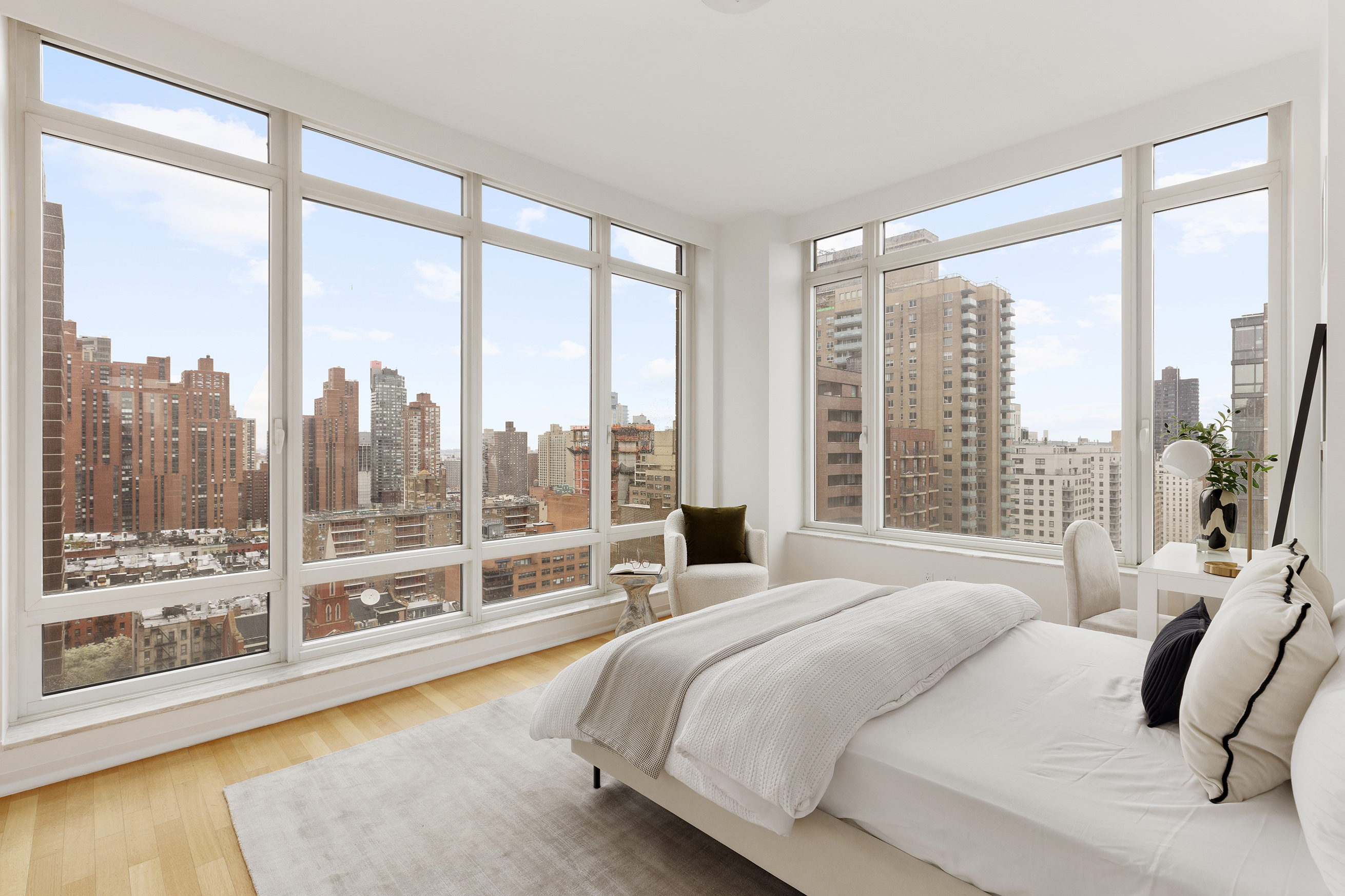 205 East 85th Street, Unit 19B Manhattan, NY 10028 - Photo 5 of 9 a bedroom with a large bed and a large window with outer view