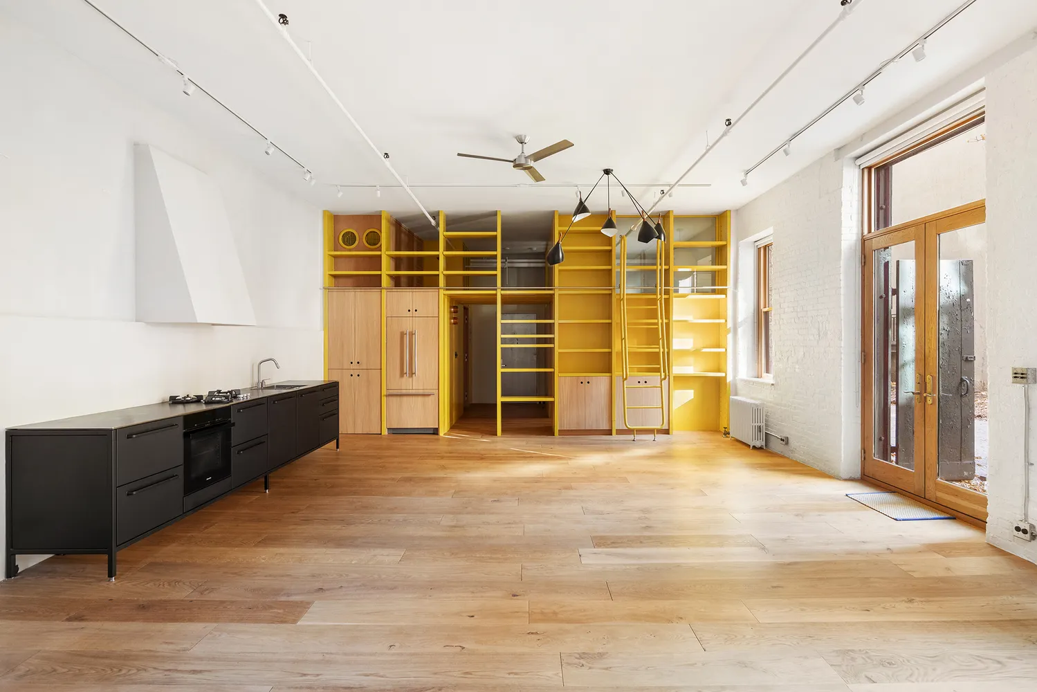 a view of a kitchen with a sink and cabinets